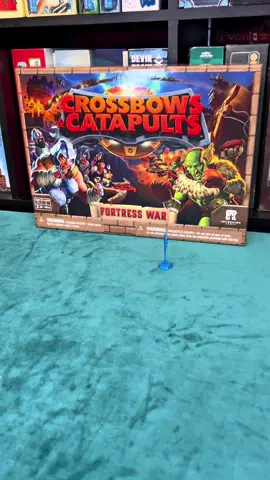 Crossbows and Catapults Players build a wall of plastic bricks to protect their fort, then alternate turns shooting the walls down using ballistae (