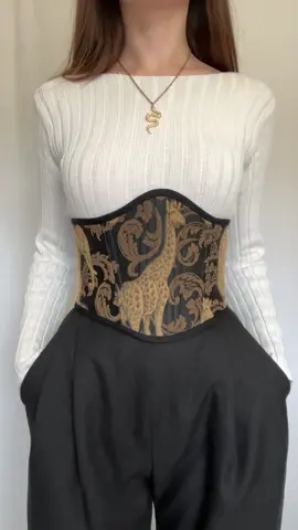 This corset is lovingly made by hand, with hand-stitched binding for a delicate, refined finish. It features upcycled animal-print fabric( cotton/acrylic)  paired with 100% black cotton, making each piece truly unique. Structured with German synthetic boning and finished with brass eyelets, it offers lasting comfort, support, and elegance. A timeless piece for those who value craftsmanship and conscious fashion. Please note that sizes M and L differ slightly#LilacLilyCorsets #corsets #underbustcorset #corsagebelt #renaissance #fairs #handmade #fashion 