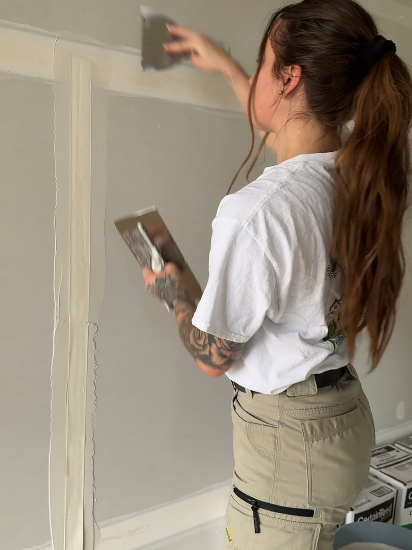 How to hand tape a joint :  First and foremost, make sure to prefill any big gaps or broken drywall on the joint. Apply a thin layer of the CertainTeed Lite Taping compound. Then, apply paper tape, cutting it to desired length and making sure the crease is facing the wall. Wipe the excess mud with your knife. #fyp #tapetok #drywall   