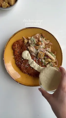 Chicken caesar pasta salad For the chicken seasoning: 2 chicken boneless breast, halved lengthwise and pounded Salt to taste  1 tbsp garlic powder  1 tsp black pepper  1 tsp smoked paprika powder  For the dry batter: 1 cup all purpose flour  Salt to taste  1 tbsp garlic powder  1 tsp black pepper  1 tsp smoked paprika powder  For the breadcrumbs: 2 cups panko bread crumbs  For the egg wash: 1 egg 1/2 cup water For the Caesar dressing:   1/2 cup mayonnaise  1 tbsp lemon juice, freshly squeezed  2 cloves fresh garlic, minced Salt to taste 1 tsp black pepper  1/3 cup freshly grated Parmesan cheese  2 tbsp extra virgin olive oil  1 tbsp Worcestershire sauce  1 tbsp Dijon mustard  For the Caesar salad: 2 cups romaine lettuce , chopped  1/2 red onion, thinly sliced  6 cherry tomatoes, halved  1 cup croutons 4-5 tbsp Caesar dressing  1 cup boiled penne pasta Salt to taste 1 tsp garlic powder  1 tsp smoked paprika powder. Method: Season the chicken with salt pepper garlic powder and smoked paprika.  Make the dry batter: In a bowl add all purpose flour, salt, pepper, garlic powder and smoked paprika.  Make egg wash: In a separate whisk an egg with water until mixed . In another bowl add panko bread crumbs. Coat the seasoned chicken in dry batter, then in egg wash , then repeat again in dry and egg wash. Lastly coat with panko bread crumbs. Heat oil to 350 F. Deep Fry the chicken for 3-4 min flipping side in between or until the chicken reaches 165 F . Once cooked through, Remove and set aside . Make Caesar dressing by combining mayonnaise, Dijon mustard, Worcestershire sauce, salt, pepper, freshly minced garlic, lemon juice, freshly grated Parmesan cheese and oil.  In a bowl add lettuce, tomatoes, onions, pasta, croutons, salt pepper, garlic powder, smoked paprika add some caesar dressing. Add more Parmesan cheese if desired. Serve with crispy chicken and enjoy. #chickencaesarsalad #saladrecipe #crispychicken #Recipe 