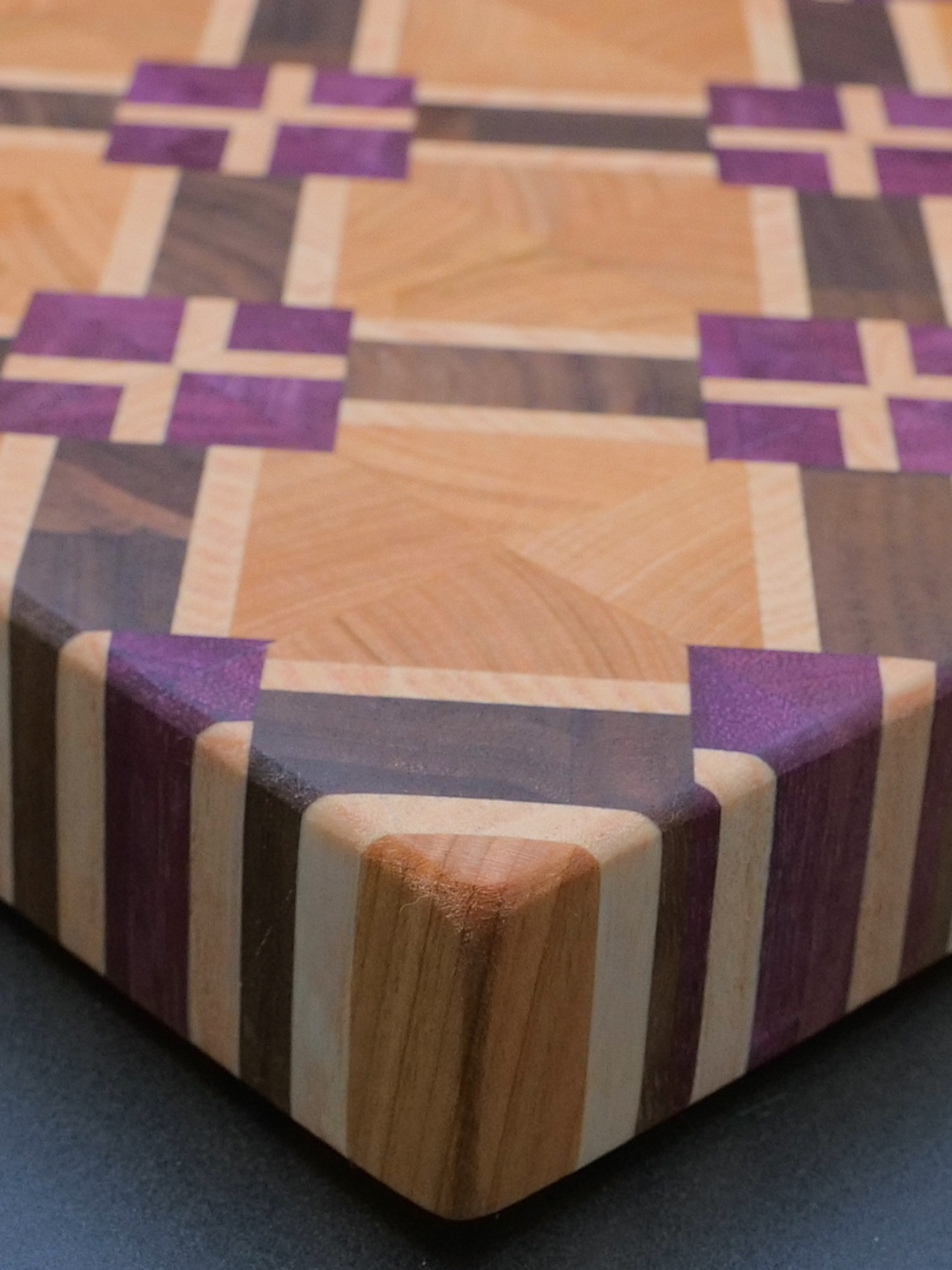 Built this bold 4-wood cutting board by hand. Purpleheart, Cherry, Walnut, Maple. Would you use it or hang it as art? 👀🪵 #woodworking