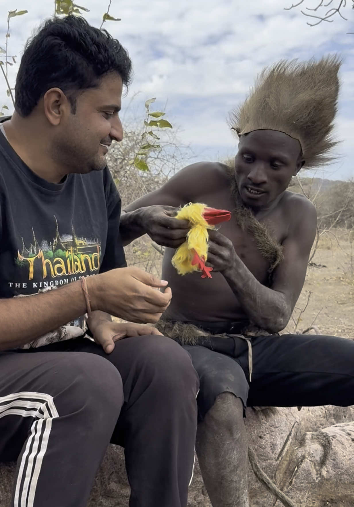 When the chicken puppet screamed… Hadzabe hunter panicked 😂🐔💥 Okay so part 2 is even more hilarious 😆 The moment that fluffy chicken toy made a noise — he literally jumped back and said “Hii poooo!” 🤣 He was scared for a second, then laughed non-stop with us! What a moment to remember with my Hadzabe fam 🫶 Stay tuned for more tribal laughter and love 💛 Full story in my YouTube vlog! 🌍 #fyp #viral #triballife #funnyvideo #reactiontime #explorepage #worldculture