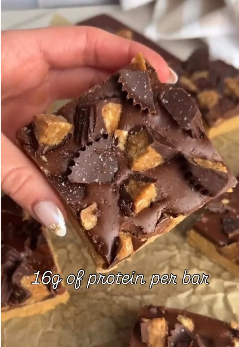 Peanut butter cup protein bars! No bake, gluten free, protein packed dessert. With a peanut butter cookie dough base, a chocolate ganache coating, and homemade protein peanut butter cups! Recipe in bio! or search colleenshealthylife peanut butter cup protein bars #proteindessert #proteinpacked #proteinbar #peanutbuttercups #glutenfreedessert #nobakedessert #lowsugar #proteinsnack 