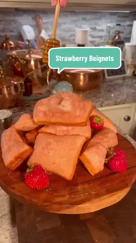 🍓 Pink Strawberry Beignets, they are better than Cafe Du Monde  Fluffy, fruity, and a fun twist on the classic—perfect for when you’re craving a little magic in your kitchen! 🐸Ingredients: • 5 tsp dry yeast • 3 tbsp sugar • ½ tsp baking soda • 1½ cups buttermilk • ½ cup boiling milk • 5½ cups (690g) bread flour • ½ tsp salt • ½ cup strawberry purée (from fresh or frozen strawberries) • Strawberry jam (optional, for filling) • Powdered sugar, for dusting • Honey (optional, for drizzling—to feel like Tiana) 🍓For the Strawberry Purée: • 16 oz strawberries • ½ cup sugar • Zest of 1 lemon To Make the Purée: Blend strawberries, sugar, and lemon zest until smooth. Set aside. 🐭🍀Let’s Make beignets 1. Activate the Yeast: In a bowl, whisk together buttermilk, boiling milk, sugar, and yeast. Let it sit for 10 minutes until bubbly, then stir in the strawberry purée. 2. Make the Dough: In a stand mixer, combine bread flour, baking soda, and salt. Pour in the strawberry-milk mixture and mix with a dough hook for 3–4 minutes until sticky but smooth. 3. Let It Rise: Transfer to a greased bowl, cover, and let rise in a warm spot for 1 hour—until doubled in size. 4. Shape the Beignets: Roll dough out on a floured surface to ½ inch thick. Trim edges and cut into rectangles, circles, or hearts for some extra fanciness (hahaha). 5. Fry Time: Heat oil to 350°F. Fry 1–2 beignets at a time, spooning hot oil over the tops. Flip after about 2 minutes, and cook until golden, puffed, and pink. 6. Finishing Touches: Dust with powdered sugar. Drizzle with honey #beignets #disneyfood #neworleansfoodie #strawberry #instagood 