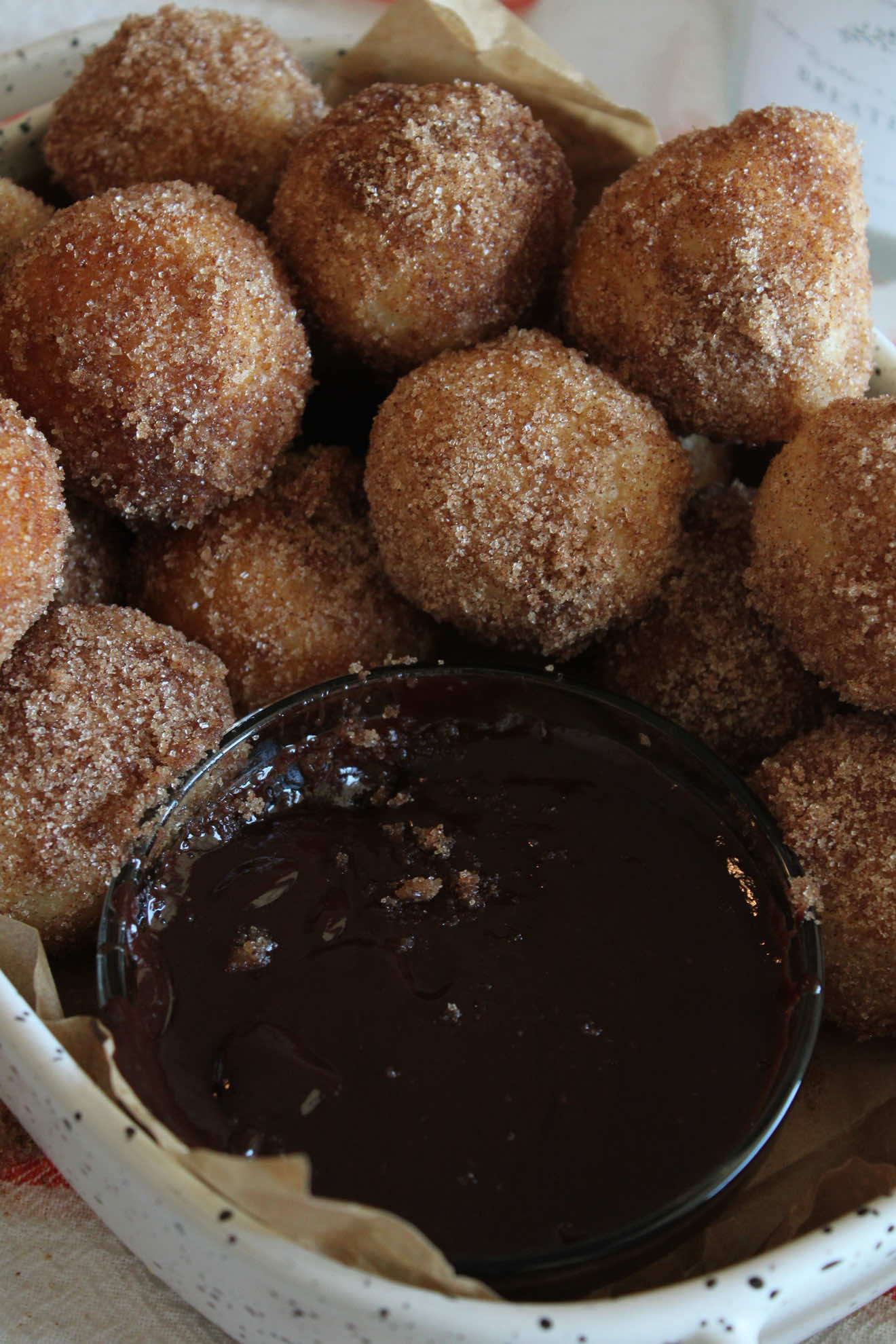 If Monday needs anything… it’s these soft sourdough donut holes 🤍✨ Rolled in cinnamon sugar, fried golden, and dangerously easy to eat. I’m sharing my recipe so you can enjoy these delicious treats — full details in the caption! Dough Ingredients 	•	560 g bread flour 	•	125 g active sourdough starter 	•	300 ml milk 	•	1 egg + 1 egg yolk 	•	60 g honey 	•	1 tbsp vanilla extract 	•	12 g salt 	•	95 g unsalted butter (softened) 	•	~2 cups neutral oil for frying (canola, vegetable, etc.) ⸻ Cinnamon Sugar Coating 	• 1 cup  granulated sugar 	•	1–2 tsp ground cinnamon (adjust to taste) 	•	Optional: pinch of salt (Mix together in a bowl or shallow dish) ⸻ Instructions 1. Make the Dough 	•	Feed your sourdough starter in the morning. 	•	Around midday, combine all dough ingredients except for the butter in a stand mixer bowl. 	•	Mix until combined and let rest for 20 minutes. 	•	Add the butter in small pieces, incorporating each one fully before adding the next. 	•	Transfer the dough to a greased bowl. Cover and bulk ferment at room temperature for 6–8 hours, doing 4 sets of stretch & folds during the first 2 hours (every 30 minutes). 	•	Refrigerate overnight (8–12 hours). 2. Shape the Donut Holes 	•	In the morning, take the dough out and let rest at room temp for 10 minutes. 	•	Divide the dough into small portions (25gr  each) and shape into tight balls. 	•	Place them on parchment paper dusted with flour. 	•	Cover and let proof for 2.5–4 hours, or until puffed and jiggly. 3. Frying 	•	Heat oil in a deep pot to 350–360°F (175–180°C). 	•	Fry the donut holes in batches for 1–1.5 minutes per side, turning as needed until golden brown. 	•	Transfer to a paper towel-lined tray. 4. Cinnamon Sugar Coating 	•	While still warm, roll the donut holes butter and then in the cinnamon sugar mixture to coat well. 	•	Let cool slightly and enjoy! — Chocolate Ganache — 	•	100 g chocolate (semi-sweet or to your preference, chopped) 	•	80 g heavy cream 	•	15 g unsalted butter ⸻ Instructions: 	1.	Heat the heavy cream until it’s just about to boil (don’t let it fully boil). 	2.	Pour the hot cream over the chopped chocolate and let it sit for 1–2 minutes to melt the chocolate. 	3.	Stir gently until smooth and glossy. 	4.	Add the butter and mix until fully incorporated. 	5.	Let it cool slightly before using, or refrigerate if you want it thicker. #donuts #donutholes  #cinnamon #sourdoughbread #EasyRecipes #bakingathome #bakingtiktok #CapCut #bakingfromscratch #desserts 