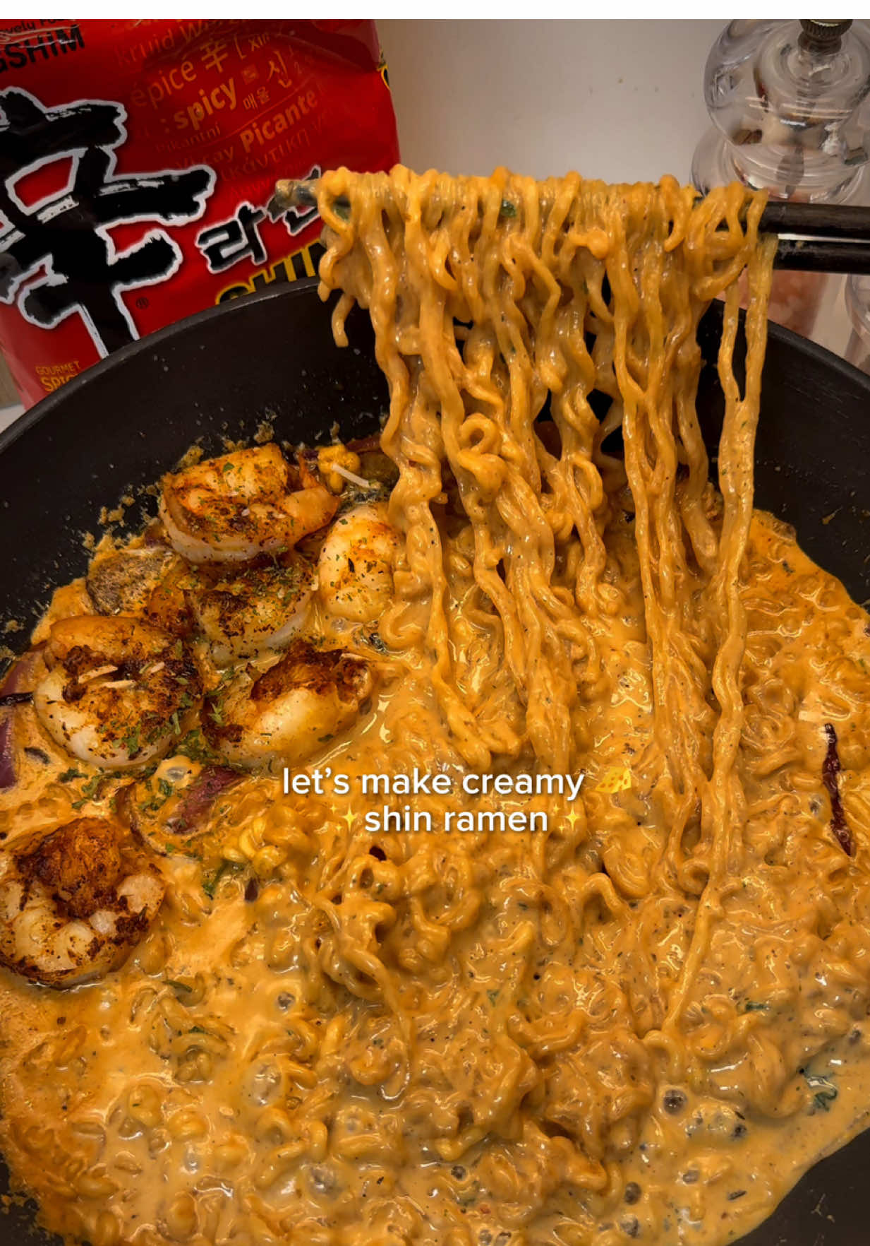 This ain’t your average Shin Ramyun🍜 Your fave Korean ramen just got a serious GLOW UP🍝✨ It’s creamy, cheesy, and brings just the right amount of heat🔥 Loaded with garlicky shrimp, buttery mushrooms, milk, and Parmesan — it’s a rich, umami-packed flavor bomb 🍤🍄‍🟫🍝 It’s giving gourmet ramen pasta night at home💗 📍Tag your ramen buddy & save this recipe for your next cozy noodle night! ✨Hailey’s Shrimp Creamy Shin Ramen✨ Ingredients 	•	1 pack of Shin Ramen 	•	1 tbsp butter 	•	¼ onion, thinly sliced 	•	2 cloves garlic, thinly sliced 	•	2 baby bella mushrooms, sliced  	•	6–7 peeled shrimp 	•	Salt & pepper, to taste 	•	Paprika powder, to taste 	•	300ml milk 	•	150ml water 	•	2 tbsp grated Parmesan cheese 	•	50ml heavy cream (optional, for extra richness) 	•	Crushed black pepper (optional) 	•	Parsley, for garnish (optional)  Instructions 1.	In a pan over medium heat, melt the butter. Add the sliced onion, garlic, and mushrooms. Sauté until fragrant and lightly golden. 2.	Push the veggies to one side, add a drizzle of cooking oil, then add the shrimp. Season with salt, pepper, and paprika powder. Sear until golden and cooked through. Remove the shrimp and set aside. 3.	Pour in the milk, water, and the Shin Ramen seasoning packet. Bring to a gentle boil. 4.	Add the noodles and dried veggie packet. Cook until the noodles are tender. 5.	Stir in the heavy cream (if using) for an extra creaminess. 6.	Serve hot, topped with the seared shrimp, Parmesan, a sprinkle of crushed pepper, and parsley. #ramenhack #asmrfood #mukbang #shinramyuntoomba #EasyRecipe #shrimppasta #fyp @Nongshim USA 