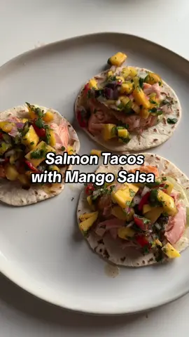 Salmon Tacos with Mango Salsa - the summer dinner of my dreams! This came together is just about 15 minutes and is bright, balanced, and sooo delish!  #healthyrecipes #healthydinner #salmonrecipes #summermeals #balancedeating 