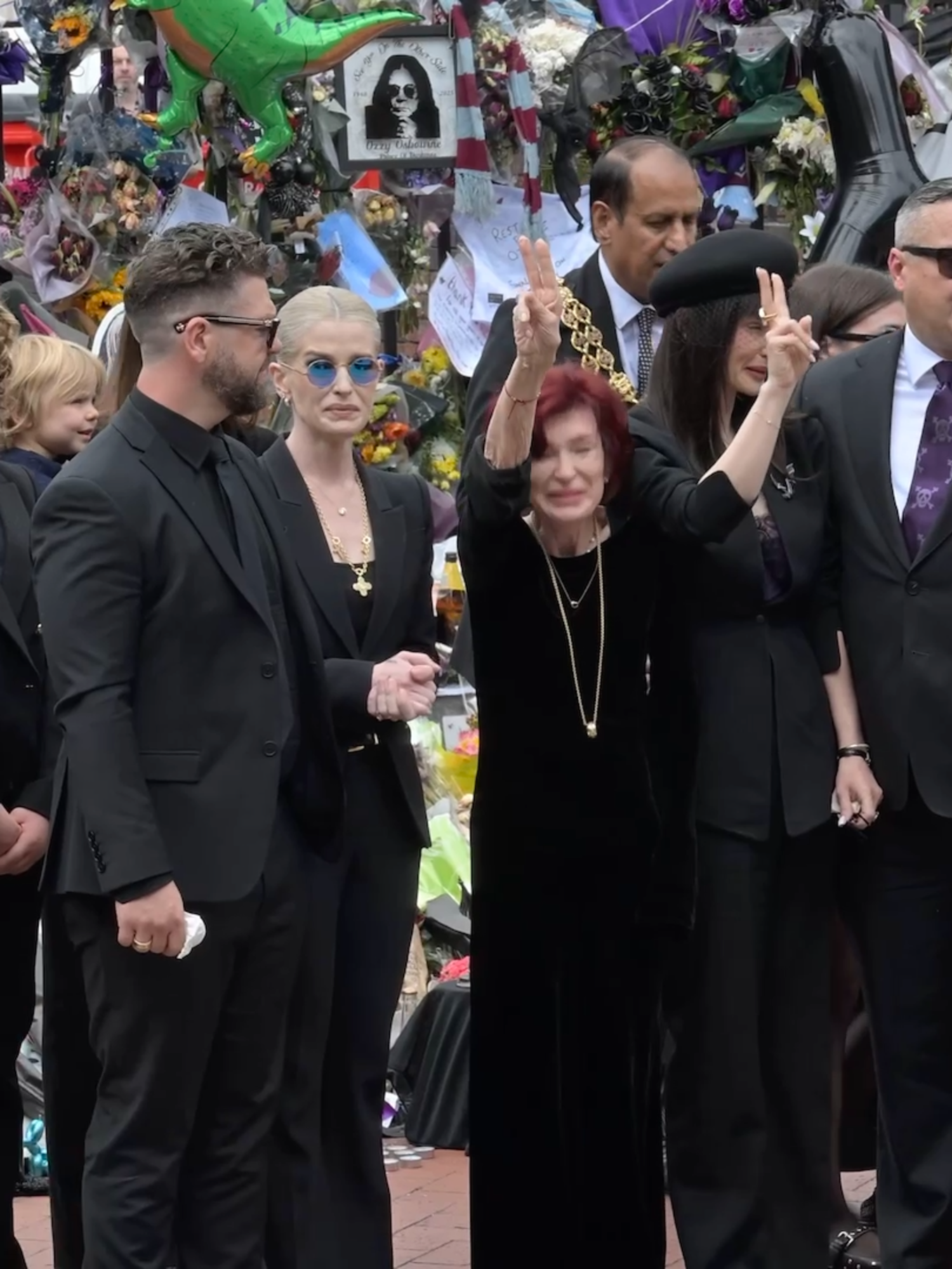Ozzy Osbourne's family visits the fan memorial near the Black Sabbath Bridge during his funeral procession in Birmingman on Wednesday. Credit: Getty Images #ozzyosbourne #sharonosbourne #ozzyforever #blacksabbath