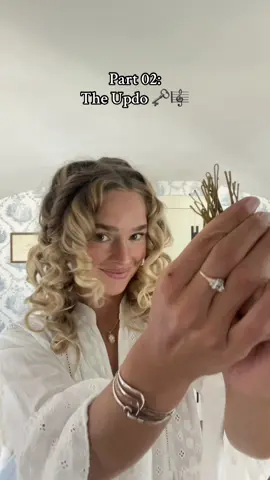 Recreating Lizzy Bennet's Updo from the Netherfield Ball in the 2005 Pride & Prejudice 🦢🕊️ [ Part 02 — The Updo ] 🗝️🎼 Note: This is a two part series as it is rather complex! You will need many bobby pins (more than imaginable, a curling wand and a good hairspray for this look) 01. 🧺 I start by gathering a section of hair above my ear to create a fishtail braid that will be used as a crown — Then I do the other side so I have two braids. 02. 💆🏼‍♀️ I gather up the front sections of my hair and then pull out all of the little facial framing pieces which will be curled up later.  03. 🌹🐑 Next is the pinning process. Remember, this does not have to be perfect as you go!! I find it easiest to start with the two sections of hair around the face/top of head and create two rosettes by wrapping the hair around my finger, rolling up the curl and then pinning it in place. 04. 🎻 I repeat this process all over my head. I try to do smaller sections of curls to create the same look as the movie which almost shows all of these individual rolls of curls all over her head piled up. 05. 🐟 I then pull each fishtail braid over my head to the opposite side and pin it above the ear at the base of the other braid to create the braid crown. 06. ➰ I curl the baby hairs around my face and nape of my next to mimic the bangs shown in the film.  07. 🦪🤏🏼 I added a few more bobby pins in a few places to make sure everything was held in place and then added the decorative shell pins — in the original look they use pearl bobby pins which I'm sure are available somewhere on the internet to buy ✨ 08. 💨🔒 Lock this all in with lots of hairspray and voila!! your regency-inspired look is ready. . . . #regencyera #janeausten #regencycore #cottagecore #hairtok #weddinghair #prideandprejudice  #lizzybennet #curls #curlinghair #volumehair #updo #weddinghairinspo #oldfashionedhair #georgianera #elizabethswann #englishliterature #prideandprejudice2005 