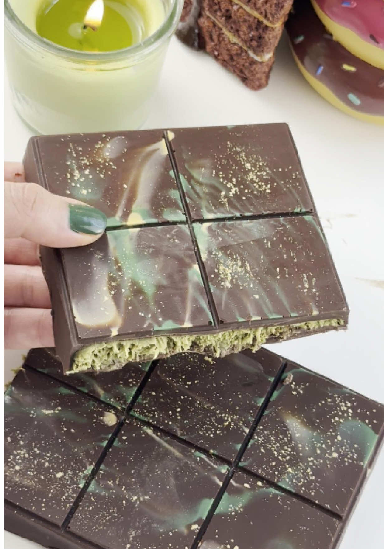 Homemade Dubai Chocolate Bar 🍫  Dark chocolate + crunchy filling = melt-in-your-mouth magic ✨ This chocolate bar is my take on the rich, fancy flavors you’ll find in Dubai—crunchy, nutty, and oh-so-satisfying 💚 🍫 How to Make: 🎨 Tint white chocolate with mango yellow + emerald green and spread it on the top 🍫 Coat the rest in rich dark chocolate 🍥 Fill with toasted kunefe crumbs mixed with silky pistachio butter ❄️ Freeze for 10 minutes 🌟 Finish with a sprinkle of edible gold glitter for that fancy Dubai flair And that’s it—ready to pop, bite, and wow your guests! 💫 Would you try these luxe Dubai chocolates?  💖 Save this for your next party treat! @elly.bakehouse @elly.bakehouse @elly.bakehouse #chocolate #dubaichocolate #kunafa #crunchy #pistachiobutter #fyp #ellybakehouse