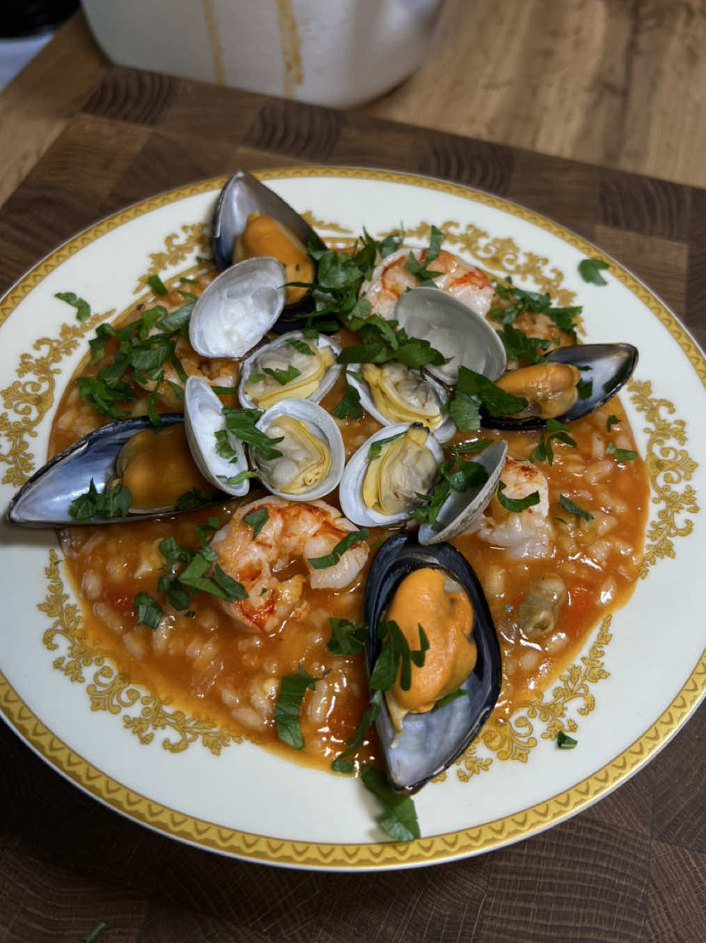 Arroz de Marisco | Portuguese seafood rice 🍤🇵🇹 Arroz de Marisco is one of Portugal's most beloved and iconic dishes. Very similar to risotto or paella, but slightly different in flavor and texture. If you are passionate about Portuguese cuisine, you should definitely make this dish.  INGREDIENTS: 200g shrimp  200g Argentine shrimp  400g mussels  500g shells 250g arborio rice  1 can chopped tomatoes  2 onion  4 garlic cloves 1 red bell pepper  thyme, cilantro sprigs, salt, pepper, bay leaves, chili flakes  olive oil 2L of water fresh parsley  INSTRUCTIONS: Peel shrimp, shells and heads fry with spices in olive oil with onion and garlic for 4-5 minutes. Then pour in water, bring to the boil, reduce the heat and cook for 30 minutes.  Boil the mussels and shells in boiling water for 2 minutes each. Do not drain the broth, leave the broth behind.  To make a stir-fry for the rice. Saute onion with garlic and pepper, add tomatoes and cook over low heat for 7-10 minutes. Add the rice and gradually add the stock until the rice is completely covered. Add the broth gradually and stir constantly so that the rice will taste better and absorb more broth. Fry the shrimp, and mix the rice with the mussels and shells. Add the remaining stock and mix thoroughly. Cover with a lid and let the dish infuse.  Serve hot, garnish with the mussels in the shells and fresh parsley or cilantro if desired. Bon appetit! 😋 #arrozdemarisco #seafoodrice #portuguesefood 