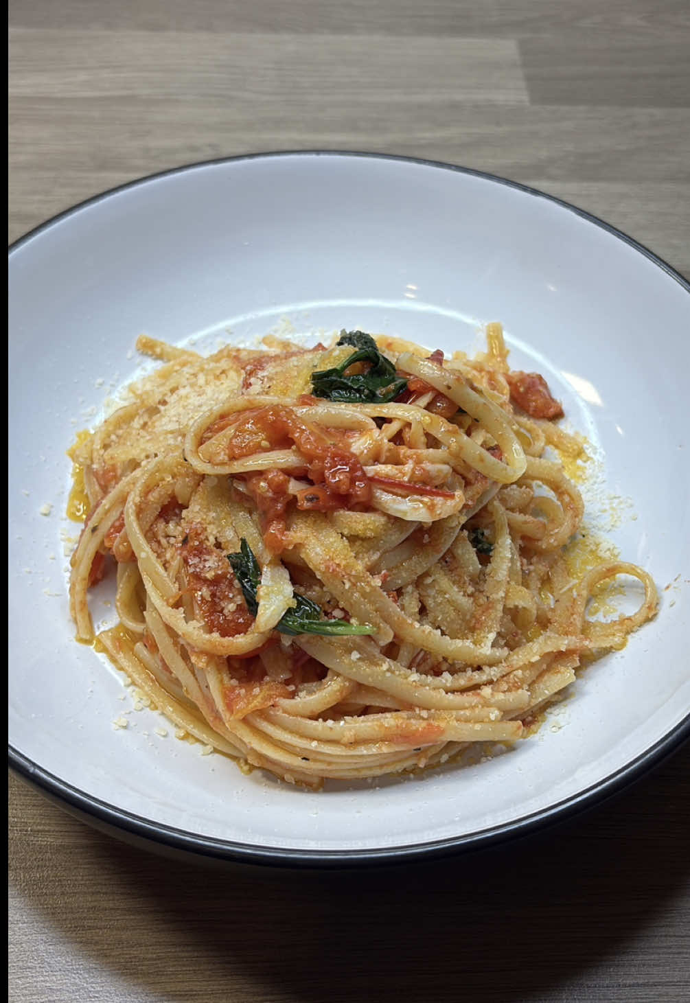 Quick and delicious homemade dinners  Simple Pasta al Pomodoro (My Way) Ingredients (Serves 2): 200g spaghetti or pasta of choice 2 tbsp extra virgin olive oil 3 garlic cloves (whole) ripe plum tomatoes, halved A handful of fresh basil Salt, to taste Black pepper, to taste  Parmigiano-Reggiano, to serve Instructions: Infuse the oil: In a wide pan over medium heat, add the whole garlic cloves to olive oil. Let them sizzle gently until golden on the outside. Remove them before they brown. Crush the garlic: Once slightly cooled, crush the garlic with the flat side of your knife to release even more flavor, then return it to the pan. Cook the tomatoes: Add the halved plum tomatoes cut-side down. Let them cook without stirring for a few minutes so they caramelize slightly. Then stir occasionally until they soften and break down — about 10–15 minutes. Season with salt and toss in fresh basil near the end. Cook the pasta: Meanwhile, boil pasta in salted water until al dente. Reserve ½ cup of the pasta water before draining. Combine: Add the pasta directly into the sauce, along with a splash of the reserved water. Toss everything together over low heat until the sauce coats the pasta evenly. Serve: Plate and finish with more basil. Add parmesan if desired — or keep it bare and beautiful. #familymeals #homemadedinner #DinnerIdeas #quickdinner #easydinner 