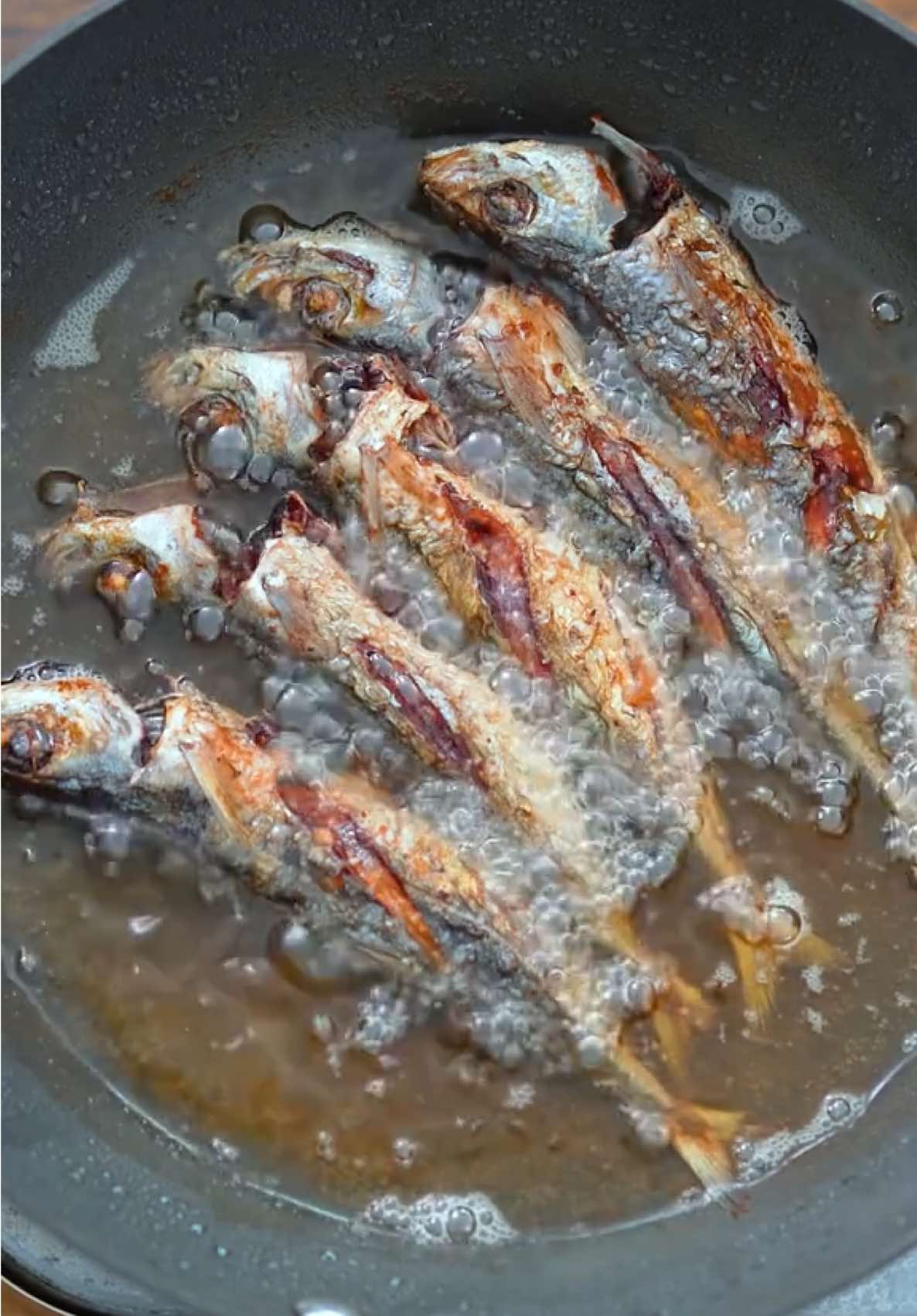 Ginataang Isda #fyp #Foodie #tiktokfood #Recipe 👇 5 pieces round scad (galunggong) 2 cups coconut milk 1 bunch baby bok choy 2 Chinese eggplants ½ cup malunggay leaves 3 thumbs ginger, julienne 1 onion, sliced thinly 5 cloves garlic, chopped 2 tablespoons white vinegar 1 cup cooking oil 2 teaspoons salt 4 grams Maggi Magic Sarap Fish sauce and ground black pepper to taste Rub Maggi Magic Sarap all over the fish. Let it stay for 10 minutes. Meanwhile, brush the sliced eggplants with cooking oil. Heat a pan and cook the eggplants for 2 minutes per side. Remove and set aside. Heat the remaining cooking oil in a wok. Fry the fish until both sides are golden brown and crisp. Set aside. Using around 3 tablespoons of the cooking oil used to fry the fish, sauté ginger, garlic, and onion until the latter softens. Pour coconut milk and let it boil. Add the vinegar. Simmer for 3 minutes. Season with fish sauce and ground black pepper. Add the long green pepper and fried fish. Cover and simmer for 3 minutes. Add bok choy, fried eggplant, and malunggay leaves. Cook for 2 minutes. Transfer to a serving bowl. Serve with warm rice. Share and enjoy!