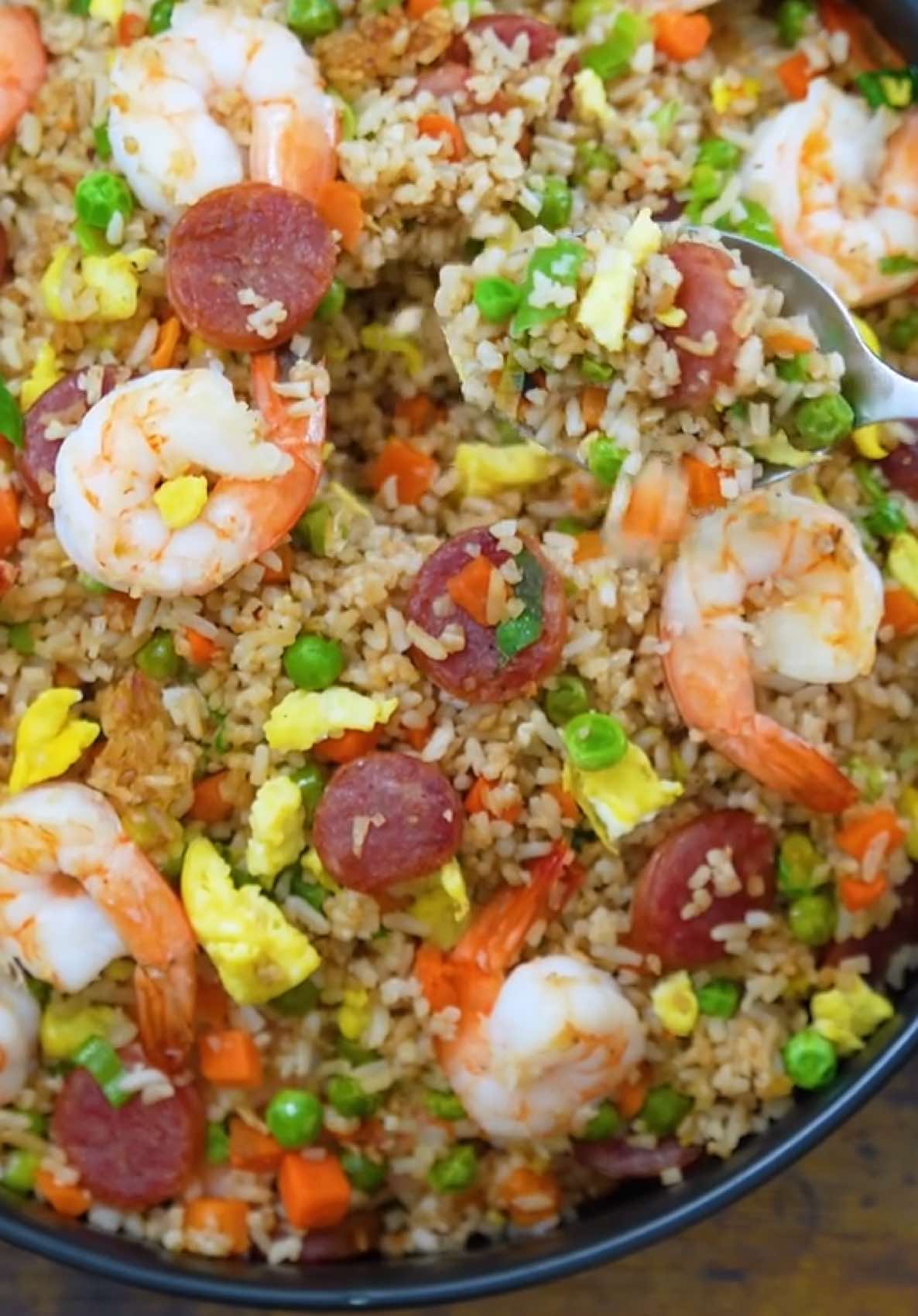 Shrimp Fried Rice #fyp #tiktokfood #Recipe  Ingredients 5 cups long grain rice cooked ¾ lb. shrimp peeled and deveined 3 pieces Chinese sausage thinly sliced crosswise 5 cloves garlic minced 1 yellow onion minced 1 ½ cups frozen carrots and green peas 3 eggs beaten 1 tablespoons soy sauce 1 teaspoon fish sauce 1 tablespoon Maggi Savor Original ½ teaspoon ground black pepper 3 stalks scallions chopped 3 grams Maggi Magic Sarap 2 tablespoons butter 3 tablespoons cooking oil Instructions Heat cooking oil in a wok or large pan. Pour the beaten eggs and scramble until just set. Season with Maggi Magic Sarap. Remove and set aside. Using the same pan, fry the shrimp for 1 to 2 minutes per side or until it turns pink. Remove and set aside. Add the Chinese sausage. Cook over medium heat for 3 to 4 minutes or until the edges start to crisp. Add the butter and let it melt. Sauté the garlic and onion until the onion softens. Add the carrots and green peas. Stir-fry for 2 to 3 minutes. Add the rice. Break it apart and toss until everything is mixed. Stir-fry over high heat for 3 to 4 minutes. Season with soy sauce, fish sauce, Maggi Savor, and ground black pepper. Mix well. Put the shrimp, sausage, and scrambled eggs back in the pan. Toss everything together. Add chopped scallions. Turn off the heat. Give it one final mix and serve.