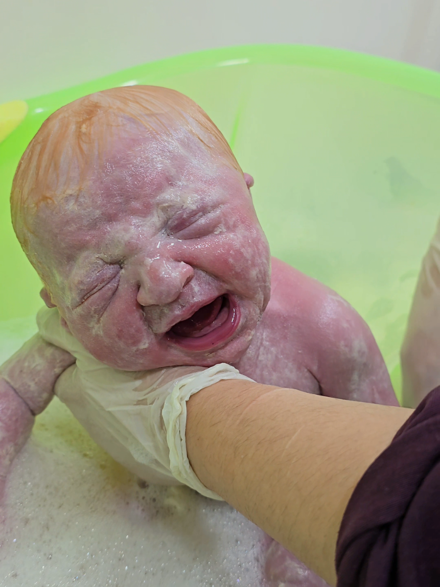 blond baby first bath 