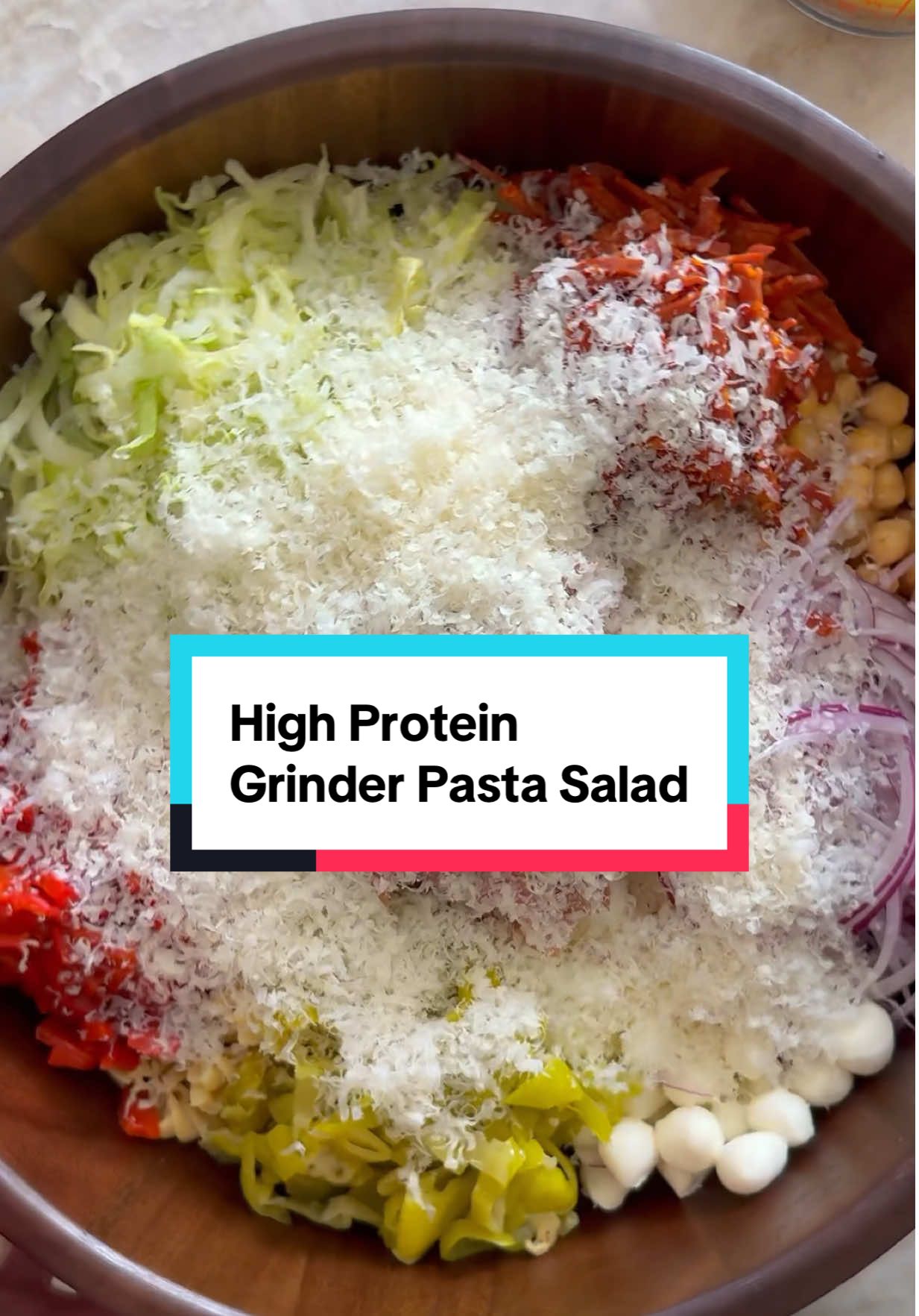 HIGH PROTEIN GRINDER SALAD with ~35g protein/serving! I have been eating @Banza🍕🍝🫘 for many years now, as an easy way to get more protein in while still getting to enjoy traditional pasta vibes! It’s made from chickpeas and each serving contains 8g fiber and 20g protein. This salad is basically a grinder salad, but in pasta form and dare I say it’s life changing?!? You decide. #BanzaPartner Makes 6 servings Salad— 1 8oz box @eatbanza rotini pasta 1 1/2 cups iceberg lettuce 3/4 cup mini mozzarella balls 1/2 cup pepperoncini 3/4 cup pepperoni, chopped 3/4 cup salami, chopped 3/4 cups red bell peppers (in a jar/can), chopped 1 can garbanzo beans, drained & rinsed 1/3 cup red onion, thinly sliced 3/4 cups parmigiano reggiano cheese, freshly grated Dressing— 1/2 cup olive oil 1/4 cup red wine vinegar  1 tb dijon mustard  1 tb oregano  2 tsp garlic powder 1 tsp kosher salt 1 tsp ground black pepper  First, prepare your dressing. Add all ingredients to a small bowl and whisk until smooth. Set aside. Cook pasta according to package instructions. Rinse and set aside. Next, chop all of your vegetables for the pasta salad. Add all of your ingredients to a large bowl, along with the pasta. Toss with the dressing and enjoy. #grindersalad #choppedsalad #viralrecipes #grindersub 
