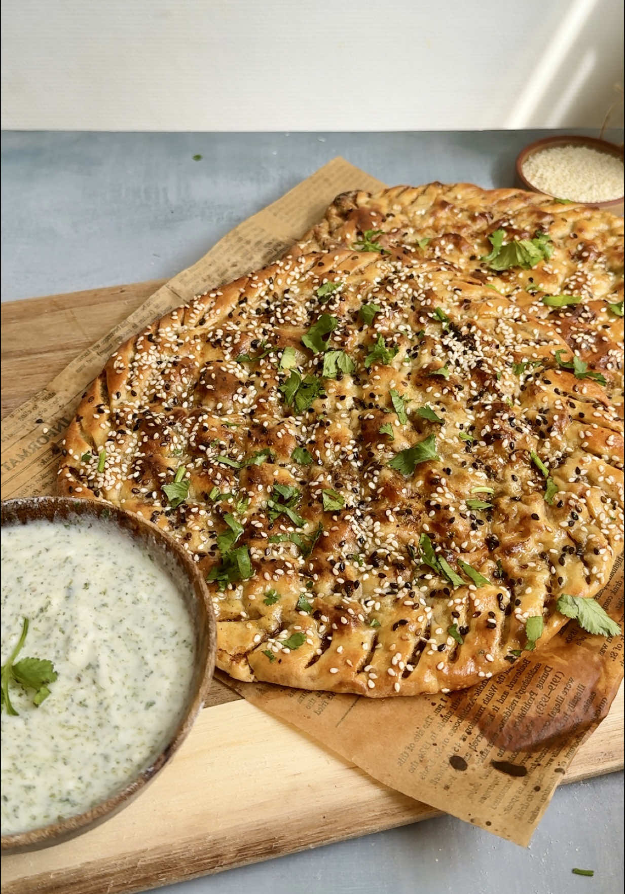 This Qeema Naan Recipe (AKA Mince Stiffed Flat bread) is soo flavorful yet so easy. Paired with a mint herb yogurt, this might be your perfect dinner! 🫓🫓 Dough 	•	3 ¼ cups (407 g) all-purpose flour 	•	1 ¾ tsp instant yeast 	•	¾ cup + 1 tbsp (190 ml) lukewarm water 	•	⅓ cup + 1 tbsp (90 g) yogurt, room temp 	•	3 tbsp (40 ml) oil 	•	¾ tsp salt  Filling 	•	500g minced meat (qeema) – beef 	•	Salt  	•	1 tsp cumin powder  .  1 tbsp coriander powder 	•	1 tsp red chilli powder 	•	2 tsp garlic paste 	•	5–6 green chillies, finely chopped 	•	1 onion, finely chopped 	•	1 tbsp fresh coriander, chopped 	•	1 tbsp tomato paste 	•	1 tsp chilli flakes Topping 	•	Egg wash (1 egg beaten with 1 tbsp milk) 	•	Sesame seeds 	•	Black seeds (kalonji) Method 	1.	In a large mixing bowl, add lukewarm water and yeast. Mix lightly and let it sit for about 8–10 minutes until it becomes bubbly and foamy. 	2.	Add flour, yogurt, oil, and salt to the yeast mixture. 	3.	Knead until a smooth, elastic dough forms. 	4.	Place the dough in a lightly oiled bowl, cover, and let it rise in a warm place until it doubles in size (about 1–1.5 hours, depending on room temperature). Prepare the Filling 	1.	In a bowl, add minced meat, salt, cumin seeds, red chilli powder, garlic paste, green chillies, onion, coriander, tomato paste, and chilli flakes. 	2.	Mix everything thoroughly. Assemble the Naans 	1.	Once the dough has doubled in size, punch it down. 	2.	Divide into 170–180 g dough balls. 	3.	Shape the qeema into 150–160 g balls and lightly coat each qeema ball in dry flour (this helps prevent moisture from seeping into the dough). 	4.	Roll out one dough ball not too thin. 	5.	Place a qeema ball in the center and wrap the dough around it to seal completely. 	6.	Gently flatten the filled dough ball with your hands, then roll very lightly with a rolling pin to spread it out. Don’t press hard. 	7.	Use your hands to make light indentations on the surface. Brush with egg wash. Sprinkle sesame seeds and Bake in a preheated oven at 220C for about 15–18 minutes, or until golden. #qeemanaanrecipe #lahoriqeemanaan  Qeema naan recipe minced stuffed flatbread recipe lahori qeema naan