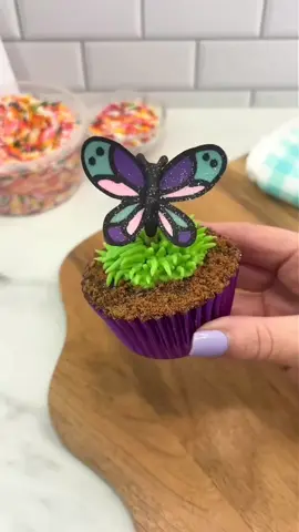 Whimsical butterfly-themed cupcake topped with colorful frosting and delicate edible wings for a charming, airy look. #cupcake #butterfly #themed #foryou #100kviews #satisfying 
