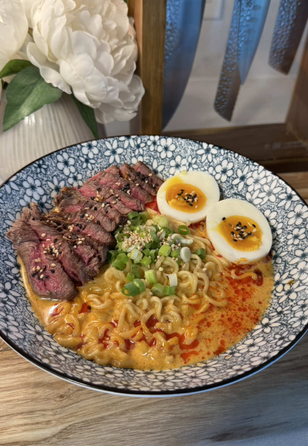 Shin black ramen 🍜✨  here is the written recipe :) Ingredients: 	•	1 pack Shin Black Ramyun 	•	2 eggs ( one for the sauce one for boiling )  	•	about 1 tablespoon Kewpie mayo  	•	 Shin Black  Ramyun soup seasonings 	•	Optional: half the veggie flakes packet ( I've seen some people add this but i don't like it )  	•	Green onions, finely chopped (for topping) 	•	Chili oil (for topping) 	•	water (for cooking noodles)         •      I small filet mignon steak Instructions: 	1.	Boil about 2-3 cups of water in a pot and cook the Shin Black Ramyun noodles according to package instructions (about 4-5 minutes). You can add the veggie flakes to the pot or leave them out. 	2.	While the noodles are cooking, in a large bowl, combine: 	•	1 egg 	•	1 tbsp Kewpie mayo 	•	2/3 of the Shin black Ramyun soup seasonings packets ( might be too salty if you add the entire thing 😐 )  Mix well until smooth and creamy. 	3.	Once the noodles are just cooked, ladle about 1 cup of the boiling noodle water into the bowl with the egg-mayo-seasoning mixture. ( you can add more or less water, do as you please and taste as you cook ! ) Stir quickly to create a creamy broth (don’t pour all the water at once to avoid scrambling the egg).  	4.	Add the cooked noodles to the bowl and stir to combine everything well. 	5.	Top with chopped green onions and a generous drizzle of chili oil (like Lao Gan Ma or homemade). For the eggs boil for exactly 6 minutes then remove them to an ice bath. This stops the cooking and makes them easier to peel ! Steak • Season steak generously with salt and pepper on both sides. • Spray or brush a pan with a light coat of oil. • Heat on high until very hot. • Sear steak for about 2 minutes per side for a nice crust (adjust time if you prefer more or less doneness). • Rest for 5 minutes before slicing #creatorsearchinsights #shinramen #ramenrecipes #foodtutorial #noodles 
