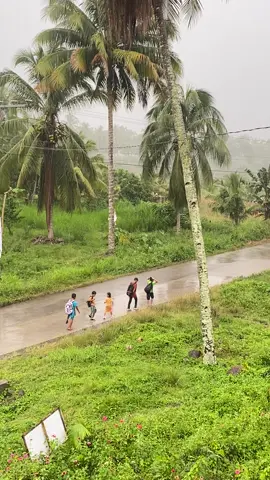 In a world that often races forward with noise and haste, there is quiet power in the simplicity of children walking home in the rain. This video, unfiltered and raw, captures more than just droplets falling from the sky it holds a thousand silent stories. Five young students, barefoot or in thin sandals, make their way along a wet concrete path. Their clothes are damp, their steps careful, and yet their spirits seem undeterred. There are no umbrellas to shield them, no vehicles waiting at the curb, just each other, and the long, soaked road ahead. In their backpacks, they carry schoolbooks. In their hearts, they carry resilience. This is not just about poverty or inconvenience. It is about strength born in the ordinary. These children teach us that life’s journeys are not always dry, smooth, or easy but they are walking with courage nonetheless. Their companionship, their shared silence or laughter in the rain, becomes a lesson in empathy, endurance, and grace. While some children worry about gadgets or grades, these students are learning bigger things: how to push forward, how to walk together, and how to find lightness even in the storm. The rain, to them, is not a burden it is simply part of the day. And maybe, just maybe, there’s something in this video that reminds us what really matters. . . . My heart is literally crying as the girl smiles and waves at me 🥹🫶🏻 maka miss maging bata. #goodolddays #studentlife #fyp