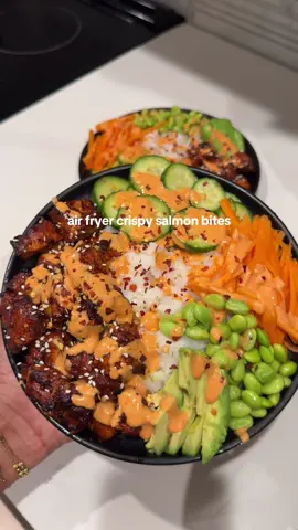 quick & easy crispy salmon bites 🍣  ~ 1 lb salmon: 1/2 cup low sodium soy sauce 1 tbsp rice vinegar 1 tsp honey 2 tsp sriracha paprika salt  black pepper ginger garlic paste   1 tsp sesame oil  spicy mayo sauce:  sriracha  kewpie mayo  - mix ingredients and salmon in a bowl, marinate salmon for atleast 15 minutes.                                        - air fry salmon at 400 degrees F for 6-7 minutes. - plate your rice, salmon, pickled cucumbers, carrots, edamame, avocado.                                    - drizzle with spicy mayo sauce, chilli flakes, and sesame seeds.  #salmonbites #recipesoftiktok #airfryerrecipes #foodietok #fyp 