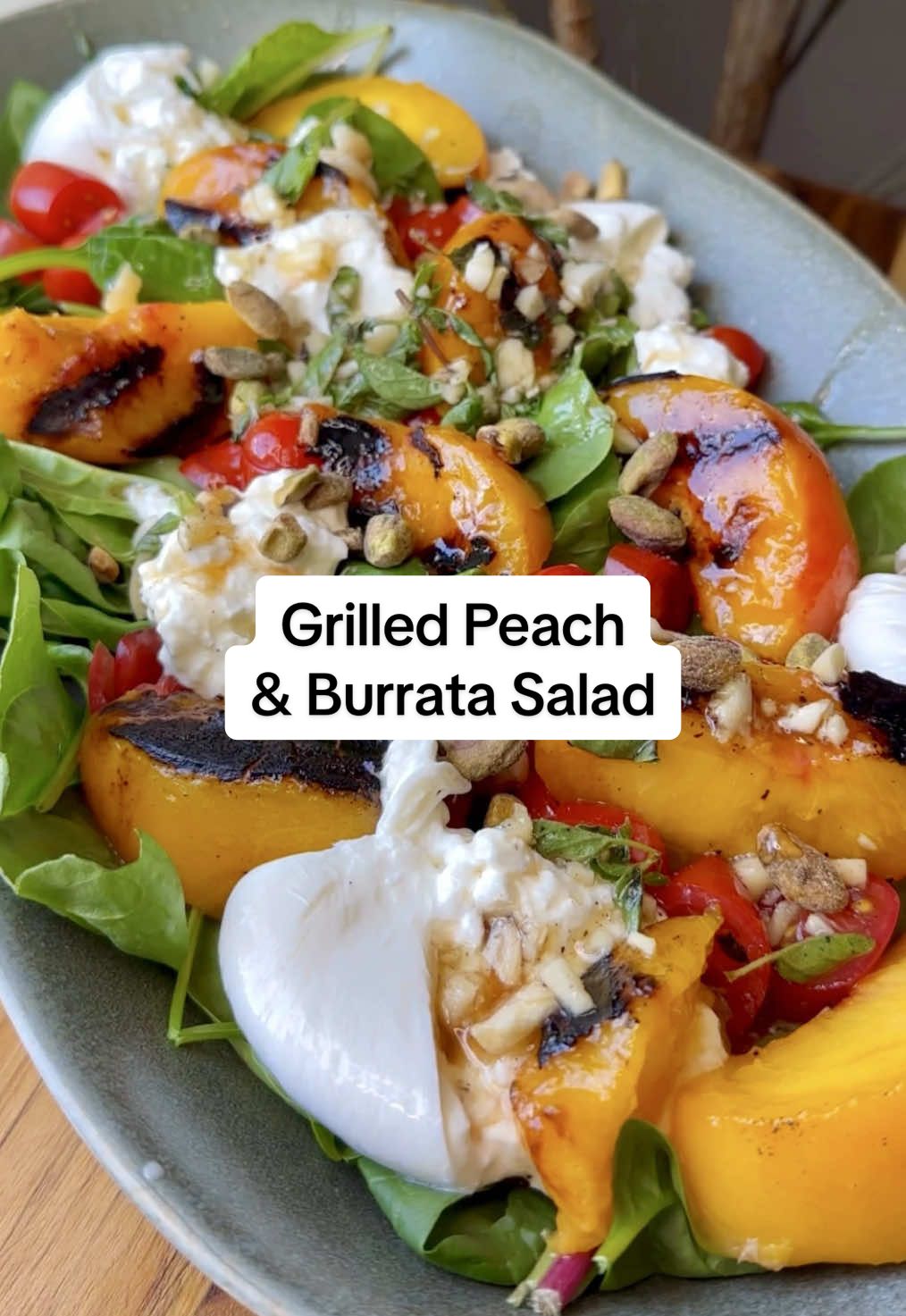 Nothing says summer like a perfectly ripe peach (just ask anyone still not over that The Summer I Turned Pretty fruit stand moment). 🍑 This Grilled Peach and Burrata Salad from @bailey rhatigan layers juicy peaches with creamy burrata, lemon vinaigrette, a drizzle of honey, and fresh basil for a sweet-savory combo that’s as gorgeous as it is delicious. Plus, eating in season means peak flavor, perfect texture, and extra nutrients from vitamin- and antioxidant-rich produce. Scroll down for the full recipe. Grilled Peaches Ingredients: 4 peaches ¼ tsp oil, for brushing ¼ tsp salt ¼ tsp pepper Dressing Ingredients: ¼ cup olive oil 1 tbsp red wine vinegar 1 tsp honey 1 tsp lemon zest ¼ cup fresh lemon juice, about one lemon 1 tbsp fresh basil, chopped ½ tbsp fresh dill, chopped ¼ tsp fresh oregano, chopped 2 garlic cloves, minced Salad Ingredients: 1 ball burrata ¼ cup pistachios, chopped walnuts or almonds also work great ⅓ cup tomatoes, chopped 6-8 cups mixed greens 1 tbsp balsamic glaze Instructions: Slice the peaches or nectarines in half with a sharp knife. Take the pit out and discard. Heat grill on medium heat. While it’s warming up, brush peaches with olive oil and sprinkle with salt and pepper. Clean the grill well before adding peaches to avoid sticking. Let the peaches sit directly on the grates for about 2-3 minutes on each side. Use a grill safe spatula to remove them and let them cool on a plate. You can also use a grill pan on the stovetop for an equal cook. Drizzle honey over the peaches. Prepare the herbed lemon vinaigrette. Chop all the fresh herbs well. Add them to a small bowl. Chop a little extra of the herbs to top the salad with for garnish. Add all vinaigrette ingredients into a bowl and whisk well. Once the peaches have cooled, carefully slice them and slice the tomatoes. In a large serving bowl or plate, layer everything over a bed of lettuce, tear the burrata into pieces and add around salad evenly. Drizzle the vinaigrette, any extra honey drizzle and any more herbs of choice for garnish. Drizzle balsamic glaze generously. Enjoy! #poosh #saladrecipe #peaches #burrata #summersalad 
