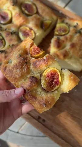 FIG & ZA’ATAR FOCACCIA Focaccia is your best baking friend in the summer. A few rounds of quick folds, very little effort, and you’ve got bouncy, pillowy bread for any occasion. I replaced the more expected cherry tomato topping with ripe, juicy figs. Works like a charm! 3 ½ c. (465 g) AP  flour 1/2 TB (5 g)  instant (rapid-rise) yeast 1 ½ c. (360 ml/g) cold water 2 tsp (10 g) kosher salt, plus more  for dimpling  1 1/2 tb (22 g/ml) olive oil, plus more for drizzling and oiling the bowl 7-8 ripe figs 8-10 sprigs fresh za’atar or oregano leaves Flaky salt, for topping Sift flour and yeast into a very large bowl. Pour the water on top; stir until mixture is a shaggy dough; rest 8 min. Add salt; knead 1 min. Let rest for 3 more min, then drizzle in the olive oil.  Knead until the dough is soft and silky (will be loose and a bit sticky). Place dough in a large oiled bowl; cover loosely with a plastic bag. Let stand in a warm place until loosened and slightly puffed 30 minutes. Gently fold dough in half over itself, rotate 90 degrees, fold in half again, rotate another 90 degrees, and fold in half once more time for a total of three folds. Cover again for a third time with a plastic bag;  rise another 30 min, then repeat folding procedure. Cover once more. Rest another 30 minutes. Repeat folding procedure once more (1 ½ hours total). Dough will be fluffy, risen, jiggly. Transfer to a well oiled 9 x 9 inch square baking dish. Cover with plastic bag; let rise another hour. While dough is rising, set a rack in center of the oven. Preheat a pizza stone at 500°F for 1 hour (or preheat a heavy baking sheet for 15 min).  Dissolve ½ TB salt in 1 c. warm water. Dip your fingers in saltwater; gently use five fingers around dough to create dimples and air bubbles.  Drizzle with olive oil, arrange the figs and za’atar sprigs around the dough, sprinkle with flaky salt, and transfer to the oven. Bake until the top is puffed and golden, 25 minutes. Cool slightly and cut into squares.    #asmr 