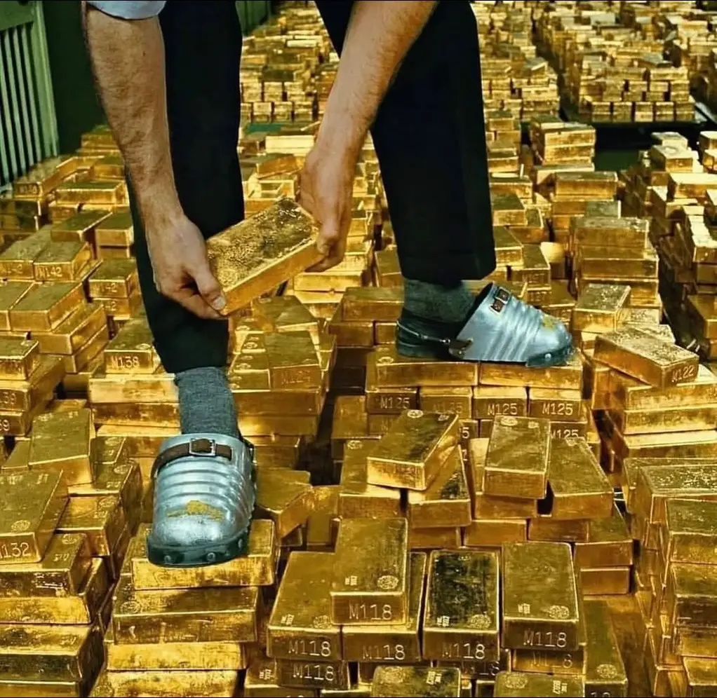 Photos of the Gold Depository at the New York Federal Reserve some of the photos are from the 1970s. The vault serves as a storage facility for monetary gold reserves, safeguarding the holdings of various account holders. At its peak in 1973, the vault held over 12,000 tons of monetary gold. As of 2024, the vault housed approximately 507,000 gold bars, with a combined weight of 6,331 metric tons. The vault is able to support this weight because it rests on the bedrock of Manhattan Island, 80 feet below street level and 50 feet below sea level.