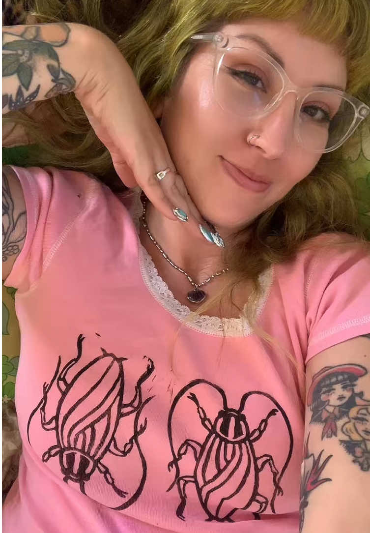🎀🪳✨ Been working on a little art project! Still working out the kinks but I kinda love it! Who needs a cockroach shirt?  #linocutprint #cockroach #tshirtprinting #whimsicalfashion #dopaminedressing  