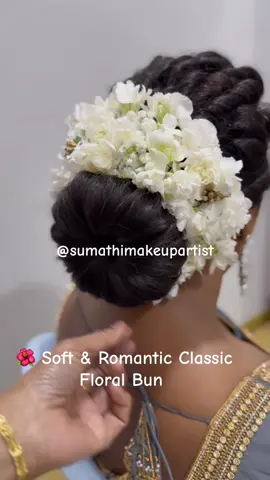 A neatly crafted low bun, wrapped with fresh white blooms for that soft and timeless bridal elegance 🤍 The floral touch adds purity and grace, making this hairstyle perfect for a classic wedding look. #sumathimakeupartist #FreshFlowerBun #BridalHair 