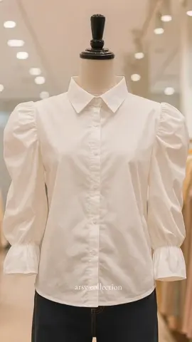 Tetap simple tapi tetap stylish! ✨ Kemeja putih dengan detail puff sleeve ini cocok untuk tampil anggun dan elegan di setiap kesempatan. Padukan dengan jeans favoritmu atau rok midi untuk look yang classy. 🤍 #OOTD #WhiteShirt #FashionStyle #MinimalistLook #ElegantStyle     