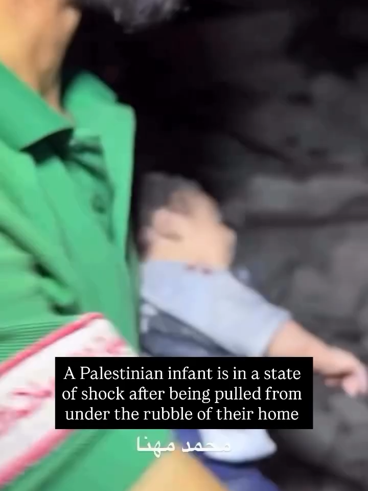 A Palestinian infant is in a state of shock after being pulled from under the rubble of their home.