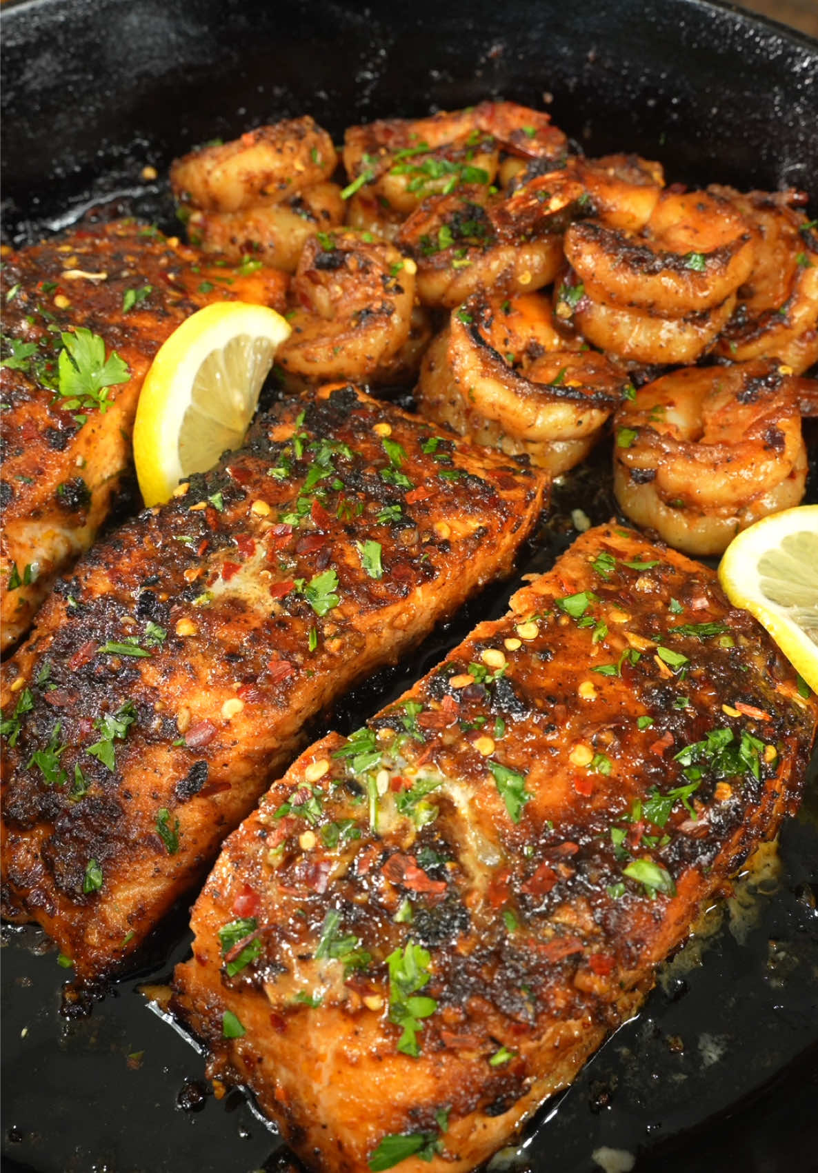 Garlic Brown Sugar Glaze Salmon and Shrimp Recipe  Salmon for 11-12 min Medium-well (130–135°F ) Shrimp for 2-3 Minutes per side (145°F) For Cooking -  Drizzle Olive Oil 3 Tbsp Salted Butter  ————- Salmon & Shrimp Seasoning - 5 (2.5 Lbs) Salmon Fillets  18 (1.2 Lbs) Colossal Shrimp, peeled & deveined Seafood Marinade -  1 1/2 Tbsp Onion Powder 1 1/2 Tbsp Garlic Powder 1 1/2 Tsp Cayenne Pepper (Adjust to spice preference  1 Tsp Paprika 1 1/2 Tsp Red Chili Flakes 2 Tsp Coarse Salt 1 1/4 tsp Coarse Black Pepper 3 Tbsp + 1 Tsp Brown Sugar Squeeze Half Lemon 6 Cloves Garlic Cloves  1 Tbsp + 2 Tsp Olive Oil 1 Tbsp + 2 Tsp Lite Soy Sauce ————————————— Garnish -  Fresh Chopped Parsley Red Chili Flakes  Lemon Juice  —————————— https://www.thatsavagekitchen.recipes/recipes/garlic-brown-sugar-glazed-salmon-and-shrimp ——————— #thatsavagekitchen #food #salmon #seafood #recipes 