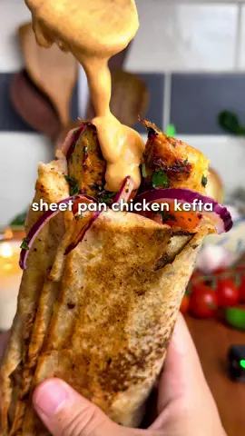 Sheet Pan Chicken Kefta Wraps 🔥  All the flavor, none of the fuss... juicy spiced chicken, roasted garlic sauce, and a zesty salad. Inspo from the recipe king: @Zachary Neman  For the Chicken Kefta: -1.5–2 lbs ground chicken (700-900 g) -2 tbsp tomato paste -8 garlic cloves, minced -2 tsp smoked paprika, 2 tsp cumin, 2 tsp salt, 2 tsp black pepper, 1 tsp turmeric, 2 tsp garlic powder -1/3 cup fresh parsley, chopped -1/3 cup fresh cilantro, chopped (optional) -1 large or 2 medium yellow onions, grated + squeezed dry* -On top before baking: 4 tbsp olive oil For the Roasted Garlic: -2 garlic heads, 1 tbsp olive oil and 1 tsp salt For the Fresh Salad: -1/2 large red onion, thinly sliced -1 cup cherry tomatoes, quartered -1/4 cup fresh parsley, chopped -1 tsp salt, 1 tsp pepper & 2 tsp sumac -Juice of 1/2 lemon Roasted Garlic Paprika Sauce: -Roasted garlic cloves, 1/4 cup mayo, 1/4 cup Greek yogurt, juice of 1/2 lemon, 1 tsp paprika + 1 tsp pepper 1. Preheat oven to 400°F (205°C). Slice the tops off two garlic heads, drizzle with olive oil and salt, wrap in foil, and roast for 45–60 minutes until golden and soft. While the garlic roasts, prep the kefta. 2. Grate the onion, squeeze out all liquid with paper towel or cheesecloth. (This prevents watery kefta.) In a large bowl, combine chicken, tomato paste, minced garlic, spices, parsley, cilantro (if using), and the grated onion. Mix with your hands for 2–3 minutes until sticky and well combined. 3. Spread onto the sheet pan in a 1/2-inch (1.25 cm) thick rectangle. With a knife, score into 1-inch strips (2.5 cm). Drizzle evenly with 4 tbsp olive oil. 4. Bake for 12–15 minutes, then broil 2–5 minutes until golden and slightly crisp on top. 5. While baking, toss onion, tomatoes, parsley, salt, pepper, sumac, and lemon juice in a bowl. 6. Squeeze roasted garlic cloves into a bowl, mash, then mix with mayo, yogurt, lemon juice, paprika, and pepper until smooth. 7. On lavash or pita, slather sauce, add 1–2 strips of chicken kefta, top with salad. Roll tight. For extra magic, crisp the wrap in a lightly oiled skillet for 1-2 mins per side.