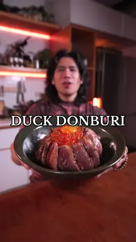 Duck Donburi 🦆🍚 INGREDIENTS: Duck: - Duck breast - Salt and pepper to taste Sauce: - 2 stalk green onion - 6pcs dried shiitake mushrooms - 1 sheet of kombu kelp - 1/2 cup mirib - 1/4 cup sake - 1/2 cup soy sauce - ½ cup sugar - 1 tsp cup of dashi powder Cured Egg Yolk: - egg yolks, whites separated - equal parts mirin and soy sauce Sushi Rice: - Japanese rice - Sushi vinegar to taste Served with: - Ikura (optional) INSTRUCTIONS: - Prior to making the dish, make some cured egg yolks with the ingredients under “Cured Egg Yolk” and allow them to sit in the fridge for 4–6 hours. - Score your duck and season with salt and pepper. Add into a hot pan and sear it to get a nice crust, and baste with oil. - Add to an oven at 200F until internal temp reaches 135F or to your liking - In the meantime, make your l sauce by combining all the ingredients under “sauce”in a saucepan. Bring the mixture to a simmer and reduce until slightly thick before removing from heat and straining the liquid. - Make the sushi rice and add it into a hangiri or a decent-sized bowl, then add some sushi vinegar and mix - Serve everything in a bowl with the sushi rice, add the sauce, and top with ikura and your cured egg yolks. Enjoy! #duck #donburi #ASMR #asmrcooking 
