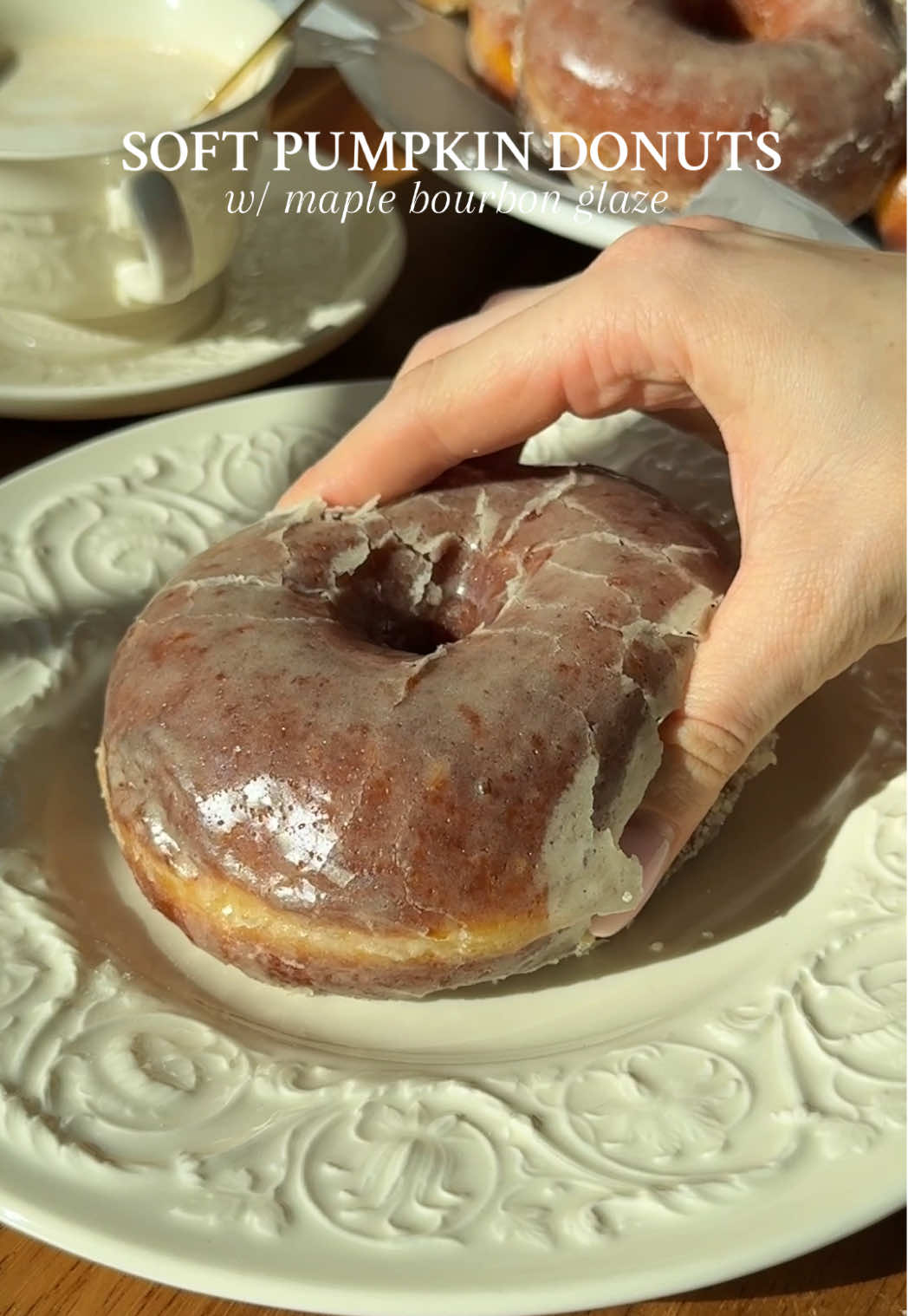 PUMPKIN DONUTS W/ MAPLE BOURBON GLAZE I mean…who else wants to rest their head on one of these and swift into sweet dreams?! because same ☁️  Recipe below OR go to my website through the link in my bio 🤎 #Recipe Details (makes 10-12 donuts): Pumpkin Donuts: - 3/4 cup (180ml) milk, warmed (~110F) - 1/4 cup (55g) granulated sugar, divided - 2 1/2 tsp (11g) active dry yeast - 1/2 cup (120g) pumpkin puree, room temp  - 1/2 cup (113g) salted butter, melted & slightly cooled - 2 eggs, room temp  - 1 tsp (4g) vanilla bean paste or extract - 4 cups (480g) bread flour (sub: all-purpose flour) - 1 1/2 tsp (3g) cinnamon - 1 tsp (2g) pumpkin pie spice - 1 tsp  (3g) salt - Avocado oil, for frying Maple Bourbon Glaze: - 3 3/4 cups (450g) powdered sugar  - 1 cup (240ml) maple syrup - 3-4 tbsp (45-60ml) bourbon whiskey, depending on desired strength of taste - 6 tbsp (90g) salted butter, melted - 2 tsp (8g) vanilla bean paste or extract - Large pinch of salt Instructions: Activate the yeast. Pour the warm milk into a small bowl or glass measuring cup. Add 1 tbsp (13g) of the granulated sugar and sprinkle the yeast overtop. Stir and allow to sit for 5-7 minutes, until frothy and activated. In a large bowl, whisk together the flour, cinnamon, pumpkin pie spice, and salt. Once activated, pour the yeast mixture into the bowl of a stand mixer (or a large bowl if mixing/kneading the dough by hand). Add the rest of the sugar, pumpkin puree, melted butter, eggs, vanilla, and the flour mixture. With the dough hook attachment (or with a wooden spoon if mixing by hand), mix on low speed for 1 minute, until barely combined. Allow to rest for 5 minutes. Then, mix on medium speed for 5-7 minutes, until the dough is elastic, smooth, and is pulling away from the sides of the bowl. If the dough seems too sticky, you can add 1 tbsp more flour at a time, until it starts to pull away from the sides of the bowl. Don’t add too much, you want the dough to be slightly sticky! I ended up adding ~2 tbsp more flour. Transfer the dough to a lightly oiled bowl. Cover and allow to rise in a warm environment for 1 hour, or until doubled in size.  Cut out 10-12 squares of parchment paper and spread them across 2 baking sheets. Lightly dust each square of parchment paper with flour.  Once the dough is doubled, punch it down and turn it onto a lightly floured surface. Roll the dough out to ~1/2” thickness. Using a 3” donut cutter, cup, or mason jar lid, cut the donuts out. Then, using a smaller 1” cutter or the wide end of a piping tip, cut out little holes in the middle of each donut. Save the little holes for donut holes or add back to the remaining dough to re-roll to cut out more donuts. You should get 10-12 donuts total. Place the donuts onto the prepared parchment paper squares on the baking sheets. Loosely cover with a kitchen towel and proof for 30-45 minutes, until puffy. While the donuts are proofing, prepare the maple bourbon glaze. In a large bowl, whisk all of the ingredients together until smooth. When the donuts are almost done proofing, fill a large, heavy-bottomed pot or Dutch oven with oil, filling ~2” in the pan. Heat on medium-high until it reaches 350F-365F. Line a wire cooling rack with a thick layer of paper towels. Once the oil is hot enough, carefully transfer the parchment paper squares with the donuts on them slowly into the hot oil, 2-3 at a time. After 10-15 seconds, pull the parchment paper away from the donuts (it should almost immediately release). Fry the donuts for 1-2 minutes on each side (2-4 minutes total), until a deep golden brown. Using a slotted spoon, carefully remove the donuts from the oil and to the rack with paper towels. Repeat. While the other donuts are frying, dip the warm donuts into the glaze, making sure to generously coat both sides. Then place onto a cooling rack to let the glaze set. Serve warm with a cup of coffee. Enjoy! #pumpkindonutswithmaplebourbonglaze #donutrecipe #homemadedonuts #fallrecipe @Le Creuset @King Arthur Baking @KerrygoldUSA