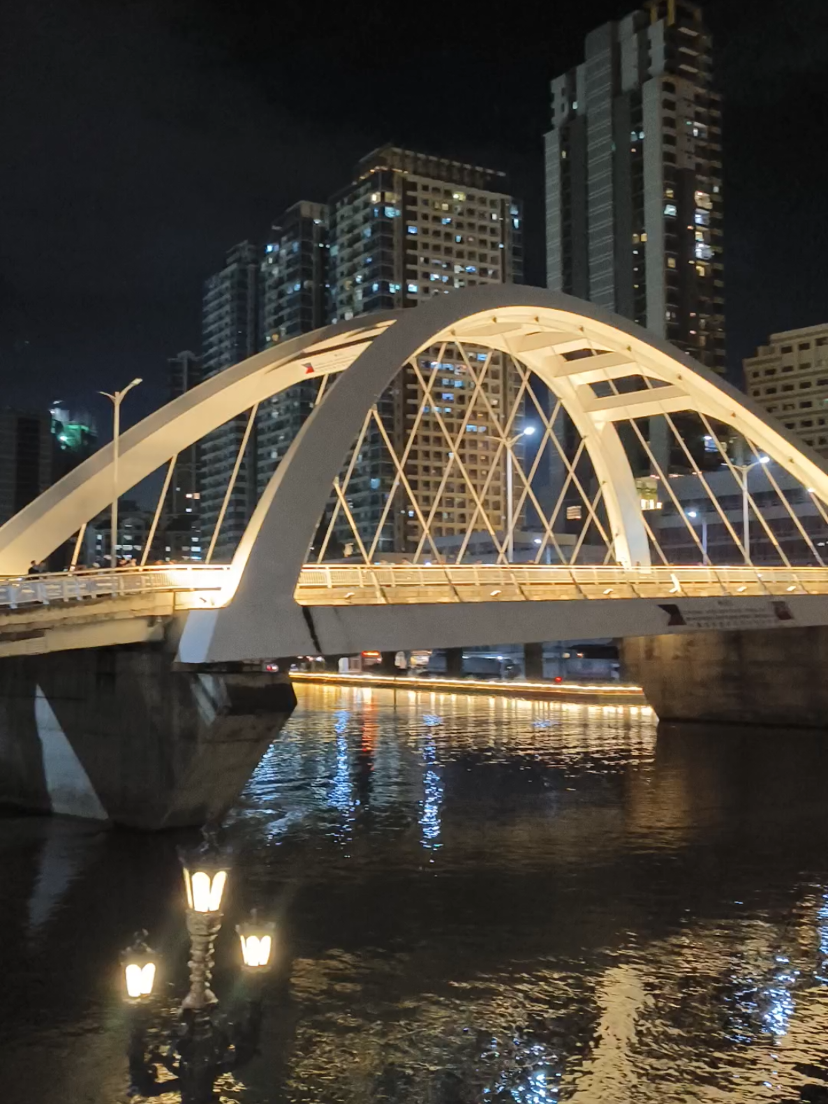 BINONDO - INTRAMUROS BRIDGE The Binondo–Intramuros Bridge is a tied-arch bridge in Manila, Philippines, spanning the Pasig River. It connects Muelle de Binondo in Binondo and San Nicolas to Solana Street and Riverside Drive in Intramuros. The bridge has four lanes and exhibits a steel bowstring arch design with inclined arches.It is 680 meters (2,230 ft) long. #intramuros #binondo #bridge #nightlight #architecture 