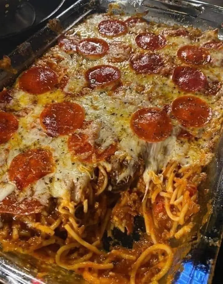 This looks fabulous Baked Pizza Spaghetti   Yummy🔥  Ingredients 1 (8 ounce) package spaghetti, broken into 2-inch pieces 2 cups shredded mozzarella cheese, divided ¼ cup milk 1 large egg, beaten ¼ teaspoon salt ¼ teaspoon garlic salt 1 (16 ounce) jar spaghetti sauce 1 teaspoon dried oregano ¼ teaspoon dried basil 4 ounces pepperoni sausage, sliced Directions Preheat the oven to 425 degrees F (220 degrees C). Grease a 9x13-inch baking dish with cooking spray. Bring a large pot of lightly salted water to a boil. Cook spaghetti in the boiling water, stirring occasionally, until tender yet firm to the bite, 8 to 10 minutes. Drain and rinse with cold water. Mix 1/2 cup mozzarella, milk, egg, salt, and garlic salt together in a large bowl. Add drained spaghetti and mix until well combined. Spread mixture into the prepared baking dish. Bake in the preheated oven for 15 minutes. Remove from the oven and reduce the temperature to 350 degrees F (175 degrees C). Spread spaghetti sauce over noodle mixture. Sprinkle with oregano and basil, then top with remaining 1 1/2 cups mozzarella. Arrange pepperoni over cheese. Return to the oven and bake until cheese is bubbly and beginning to brown, about 30 minutes. Let stand for 5 minutes before cutting. Enjoy ❤