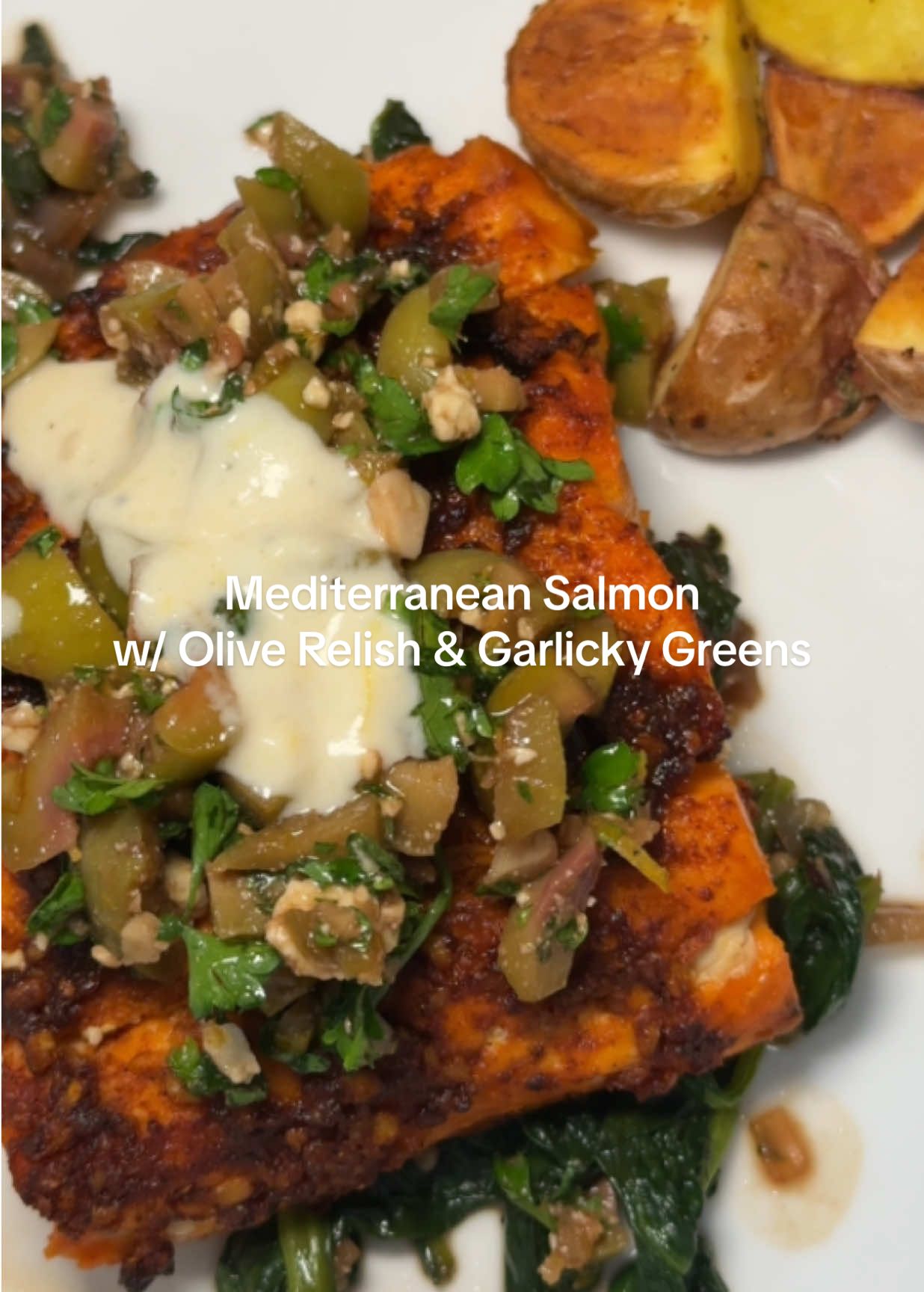 Mediterranean Salmon with Olive Relish & Garlicky Greens. Husband is not an olive fan but even he approves. This was soooo good ✨ Ingredients Salmon 	•	2 salmon fillets 	•	2 tbsp olive oil 	•	2 cloves garlic, minced 	•	Zest + juice of 1 lemon (reserve juice for relish) 	•	1 tsp smoked paprika 	•	½ tsp cumin 	•	Salt + pepper 	•	1 tsp honey (for finishing) Relish 	•	⅓ cup Kalamata olives, chopped 	•	¼ cup parsley, chopped 	•	2 tbsp olive oil 	•	1 tbsp balsamic vinegar or lemon juice 	•	⅓ cup feta, crumbled Greens 	•	1 bunch spinach 	•	1 shallot, thinly sliced 	•	2 cloves garlic, minced 	•	Pinch of chili flakes 	•	1 tbsp olive oil 	•	Splash of white wine or balsamic vinegar 	•	2 tbsp toasted pine nuts - optional  Optional Sauce 	•	2 tbsp tahini 	•	2 tbsp coconut yogurt 	•	Juice of ½ lemon 	•	1 clove garlic, grated 	•	Water to thin Instructions 	1.	Marinate salmon: In a bowl, whisk olive oil, garlic, lemon zest, smoked paprika, cumin, salt, and pepper. Rub onto salmon fillets. Marinate 30 min if possible. 	2.	Bake salmon: Place salmon on a lined baking sheet. Bake or air fry at 400°F for 12–15 min until just cooked through. Drizzle with honey before serving. 	4.	Make relish: Mix olives, parsley, olive oil, vinegar/lemon juice, and feta. Toss gently. 	5.	Cook greens: Heat olive oil in a skillet. Sauté shallot until softened. Add garlic and chili flakes. Add greens and cook until just wilted. Deglaze with a splash of wine or vinegar. Finish with toasted nuts. 	6.	Optional sauce: Whisk tahini, yogurt, lemon juice, and garlic. Thin with water until drizzly. 	7.	Plate: Place salmon on plates. Spoon relish on top. Serve greens on the side with nuts. Drizzle with tahini sauce if using. Enjoy 🫶   #easymeal #dairyfreerecipes #easydinnerideas #DinnerIdeas #dairyfree