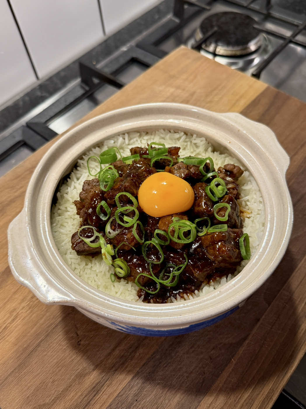 Steak claypot rice with banana leaf by chef @mamajoleneyu ! Easy and delicious weeknight dinner, so much flavour + aroma Serves 2 For the rice: 50g unsalted butter 1 tsp sea salt flakes 250g jasmine rice 1 banana leaf For marinating the steak: 500g sirloin steak 1 tbsp sesame oil 1 tbsp light soy sauce 1/2 tsp white pepper 1 tsp black pepper For the sauce: 3 garlic cloves 1 banana shallot 30g butter 1/2 tbsp brown sugar 1 1/2 tbsp caramel syrup (we use Masakan) 1 tbsp light soy sauce 1 tsp black pepper 1/2 tsp MSG 3 tbsp Shaoxing wine 1 tsp cornstarch + 1 tbsp water (cornstarch slurry) 70ml water Egg yolk, to serve Sliced spring onion greens, to serve Vegetable oil, to fry Line the bottom of a claypot with a washed banana leaf, add 50g butter and melt over low heat. Add the washed jasmine rice and pour in enough water to cover until just at your first knuckle when you touch the rice. Cover with a lid and simmer on low heat for 18 minutes. Slice the steak into cubes, then season with sesame oil, light soy sauce, white pepper and black pepper. Set aside to marinate .  Mince the garlic and slice the shallot. Heat a little vegetable oil in a pan and fry the marinated steak cubes until partially cooked. Add garlic and shallot, fry for about 30 seconds. Add 30g butter and stir until melted. Mix in brown sugar, caramel syrup, light soy sauce, black pepper and MSG. Mix well, then remove the steak cubes, leaving the sauce in the pan. Add Shaoxing wine, cornstarch slurry and 70ml water. Stir until slightly thickened, then remove the sauce from heat. Top the rice with the steak cubes and pour over the sauce. Crack an egg yolk on top and garnish with sliced spring onion greens.