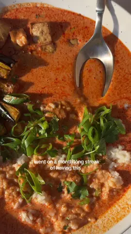 Thai red curry broth over miso butter rice 🍛🌿🍆❤️ I’ve been making a rendition of this meal for years. It’s creamy, spicy, bold, and easy to make - my favorite go-to dinner. It’s delicious with roasted eggplant and tofu but feel free to customize to your liking. 🫶 For the Thai red curry broth: 4 ounces + 1 tablespoon red curry paste* 1 teaspoon grated ginger Zest of 1 lime 1 teaspoon curry powder 1-13.5 ounce can full-fat coconut milk  1/2 cup vegan chicken broth 1 teaspoon tamari 1 teaspoon brown sugar Juice of 1/2 lime For the eggplant: 1/2 large globe eggplant, cut into strips 1 1/2 tbsp olive oil 1/2 tsp salt and pepper For the tofu: 1 block extra firm tofu, pressed and cubed 1 tbsp olive oil 1 tbsp tamari 1/2 tsp garlic 1/2 tsp coriander 1/2 tsp umami or mushroom powder, optional 1 tsp cornstarch In the bowl: -roasted eggplant and tofu -miso butter rice (recipe one post back) -scallions -cilantro Method: Preheat the oven to 425. Toss the eggplant in olive oil, salt, and pepper. Toss the tofu in olive oil, tamari, garlic powder, coriander, and umami seasoning. Then add cornstarch and toss again. Place on a parchment lined baking sheet with the eggplant. Bake for 25-30 minutes until crispy. Heat neutral oil in a skillet or pot on medium. Add the curry paste, ginger, and lime zest and cook for 2-3 minutes until the paste darkens and everything is fragrant. Add the coconut milk, broth, tamari, and brown sugar and stir or whisk to combine. Gently simmer, uncovered, for 5-7 minutes until warmed through. Remove from heat and squeeze in the lime juice. *Note: we are crazy for curry paste so we do the additional tablespoon but you can omit if you aren’t crazy #EasyRecipes #plantbaseddinner #redcurry #vegancurry