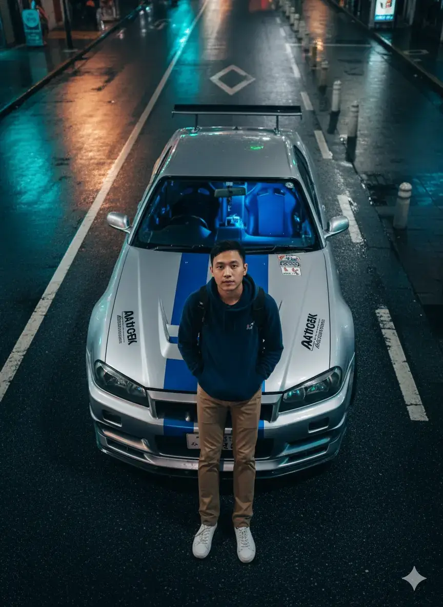 Style & Ambiance Photorealistic style with typical city nighttime lighting. Dominant colors: neon blue, metallic gray, and streetlights. Mysterious and urban atmosphere, Japanese street racing style. Main Subject (Human) A typical young Indonesian man standing leaned against a sports car. Wearing a dark blue hoodie, dark pants, and white sneakers. Black backpack on his back, hands in his pockets. Glance looking up at the camera (overhead angle). Vehicle (Sports Car) Silver sports car with blue stripes typical of street racing. Design resembles a Nissan Skyline R34, full body kit. Modified stickers and Japanese writing on the hood. The car's interior emits a blue glow from within. Environment Location at night on the side of the road, dark asphalt with white lines. Sidewalk with blue tiles and white poles. City lights create a futuristic and dramatic feel. Light reflects off the car's surface, creating a cinematic effect. Color & Lighting Nuances Dim lighting with blue and green neon effects. High contrast between the shiny car and the dark background. Reflections Street lights on the car body and wet asphalt photo  #Gemini  #ai 