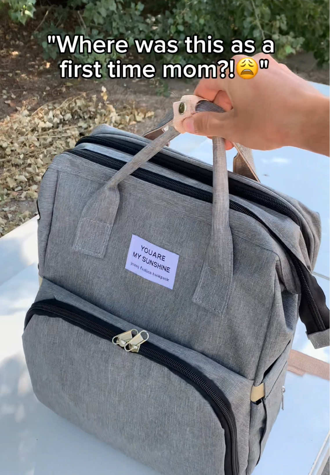 Diaper blowout in the middle of the park? 😩🌳 This diaper bag unfolds into a clean, comfy station right on the spot. . . . #diaperbag #momlife #babygear #changingpad #parentinghacks   