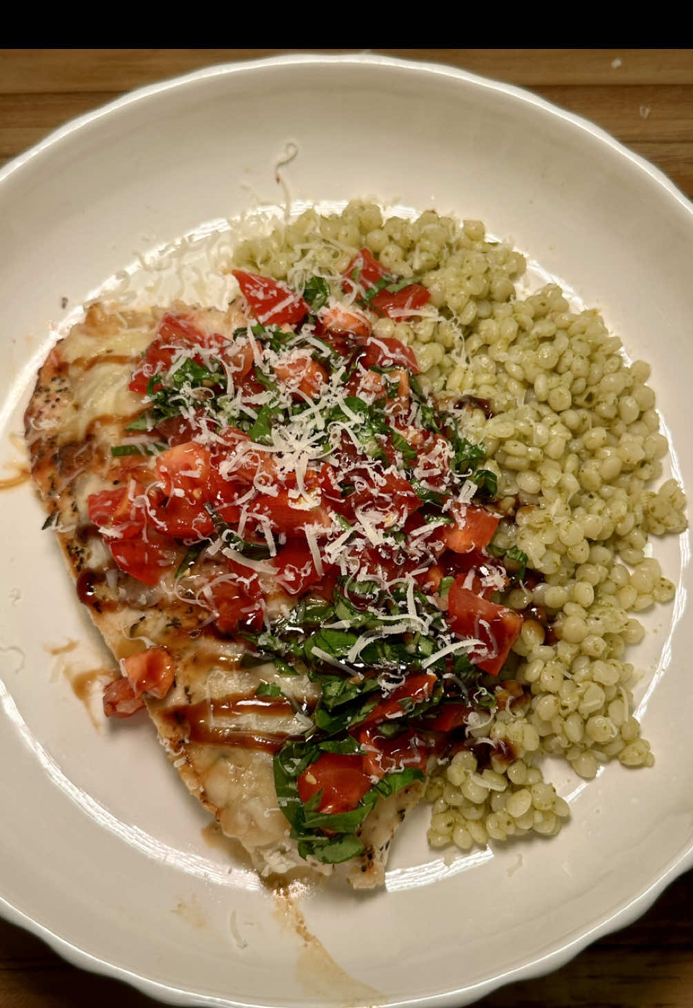 Can you believe theres only 11 days left of summer? 🥹 CHICKEN BRUSCHETTA 🍅 Ingredients  - 2 chicken breast - salt & pepper - 1 tsp garlic powder  - 1 tsp Italian seasoning - shredded mozzarella  - balsamic glaze - tomatoes  - fresh basil - 2 garlic cloves - olive oil - couscous  - pesto (homemade or store bought) - parmesean cheese Instructions  1. Slice your chicken breast in half and pound thin until they are all the same thickness, then seasoned with salt, pepper, garlic powder, and Italian seasoning. 2. Add 2 cups of water to a pot and bring to a boil with salt once it’s boiling add 1 cup of couscous. Lower the heat and cover and cook for 15 minutes. 3. Heat 1 tablespoon of olive oil in a pan and cook your chicken. When you flip the chicken over, add your shredded mozzarella cheese on top and cover the pan with a lid to let that melt for about three minutes. 4. While the chicken is cooking dice up your tomatoes and add to a bowl with freshly chopped basil, crushed garlic, salt, and olive oil. 5. add a tablespoon of pesto to your couscous once it’s done cooking. 6. Serve chicken over couscous with your bruschetta sauce, a drizzle of balsamic glaze and some fresh Parmesan cheese.  - #EasyRecipes #cooking #dinneridea #food #mealideas 