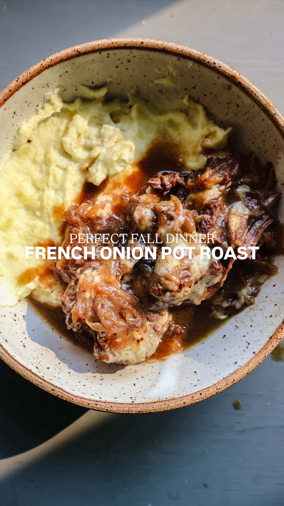 French onion… but make it a pot roast. Slow-cooked beef simmered with caramelized onions, savory broth, and melty cheese — the ultimate cozy dinner. INGREDIENTS 3-4 lb chuck roast 1 tbsp oil 1/4 cup butter 3 large white onions thinly sliced 1 tsp salt 1/2 tsp pepper 3 cloves garlic minced 1/2 cup white wine 2 tbsp balsamic vinegar 1 tbsp Worcestershire sauce 2-3 sprigs of thyme 2 cups beef broth 1 tbsp cornstarch 1 cup gruyere cheese shredded INSTRUCTIONS Season chuck roast liberally with salt and pepper. You may need to cut down the roast into smaller pieces to fit in the dutch oven to sear. I cut mine into 4 large pieces, removing extra fat.  Add oil to a 5 quart dutch oven and heat over medium heat. Add roast and sear on all sides. Remove seared meat from dutch oven and set aside for later.  Preheat oven to 325.  Add butter to dutch oven. Once hot and melted, add the onions, salt and pepper, and allow them to cook down and deeply caramelize for about 20 to 25 minutes, stirring frequently, until the onions become very dark, soft and jammy.  Add in the garlic and thyme, wine, Worcestershire, balsamic, and allow it to bubble up and reduce for about 30 seconds. Then pour in the beef stock and whisk or vigorously stir to blend in and combine until smooth. Allow the French onion sauce to simmer to 5 minutes.  Nestle the seared roast into the onion sauce, spooning onion mixture on top of roast.  Cover and place into oven and bake for 3-4 hours.  Remove roast from oven and pull apart meat with two forks.  In a small bowl combine cornstarch with 1 tbsp water and pour into roast mixture to thicken the sauce.  Serve mixture over mashed potatoes and a sprinkle of shredded gruyere cheese.  #frenchonion #frenchonionsoup #braisedbeef #weekenddinner #sundaydinner @beefitswhatsfordinner @Graza 