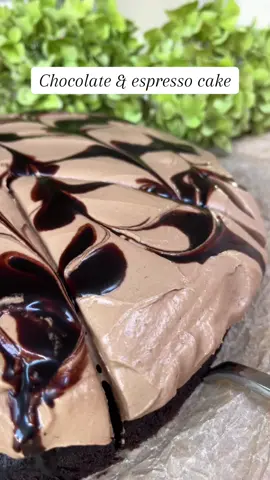 Moist chocolate cake meets silky espresso ganache – the ultimate coffee-chocolate dessert you NEED to try!😩🤎 Chocolate & Espresso Cake with Espresso Ganache Frosting recipe ⤵️ Ingredients: 🍫 Chocolate Cake: • 80 g brown sugar • 180 g granulated sugar • 180 g all-purpose flour • 60 g cocoa powder • 1 tsp baking powder • 1 tsp baking soda • 1 pinch of salt • 2 eggs • 175 g full fat milk • 175 g strong coffee or espresso (hot) • 75 g neutral oil ☕️ Espresso Ganache Frosting: • 250 g dark chocolate • 250 g heavy cream • 50 g cold espresso • 250 g mascarpone (room temperature) • 1 pack @dr.oetker_deutschland’s Vegegel 🍰 Decoration: • 50 g melted dark chocolate Instructions:  1. Preheat the oven to 175°C (350°F). Grease a 22 cm (9-inch) springform pan and line the bottom with parchment paper.  2. Mix all the dry ingredients in a bowl. Add the eggs, milk, hot coffee, and oil, and stir until you get a smooth and fairly runny batter.  3. Pour the batter into the pan and bake for about 35–40 minutes. A cake tester should come out with a few moist crumbs. Let cool and prepare the frosting. 4. Prepare the Frosting: Melt chocolate and cream over a water bath, then remove from heat and let cool. Add espresso, mascarpone, and vegegel, then gently beat with an electric mixer until fluffy and stable. 5. Assemble & Decorate: Spread the frosting evenly over the cooled cake. Place dollops of melted chocolate on top and swirl with a stick to create a marbled pattern. Serve and enjoy! #baketok #bakingrecipe #bakersoftiktok #chocolatecake #coffeecake 