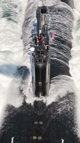 USS Submarine Surfaces with Crew on Deck! A stunning, high-angle view of a U.S. Navy submarine as it cruises on the surface of the ocean. The crew can be seen on the sail, with the American flag flying proudly. Witness the power and scale of a nuclear-powered submarine in action! #submarines #USNavy #military #ocean #navy    
