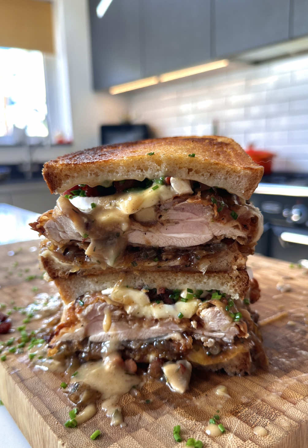 Fried chicken fricasse toastie 🫡 Started with a base of a mozzarella and gruyer toastie then added: • Fricasse sauce • Caramelised onion & bacon jam • Fried chicken thighs • More sauce • Brie • Crispy bacon lardons • Chives (for health) #fyp #food #foodporn #foodphotography #sandwich        