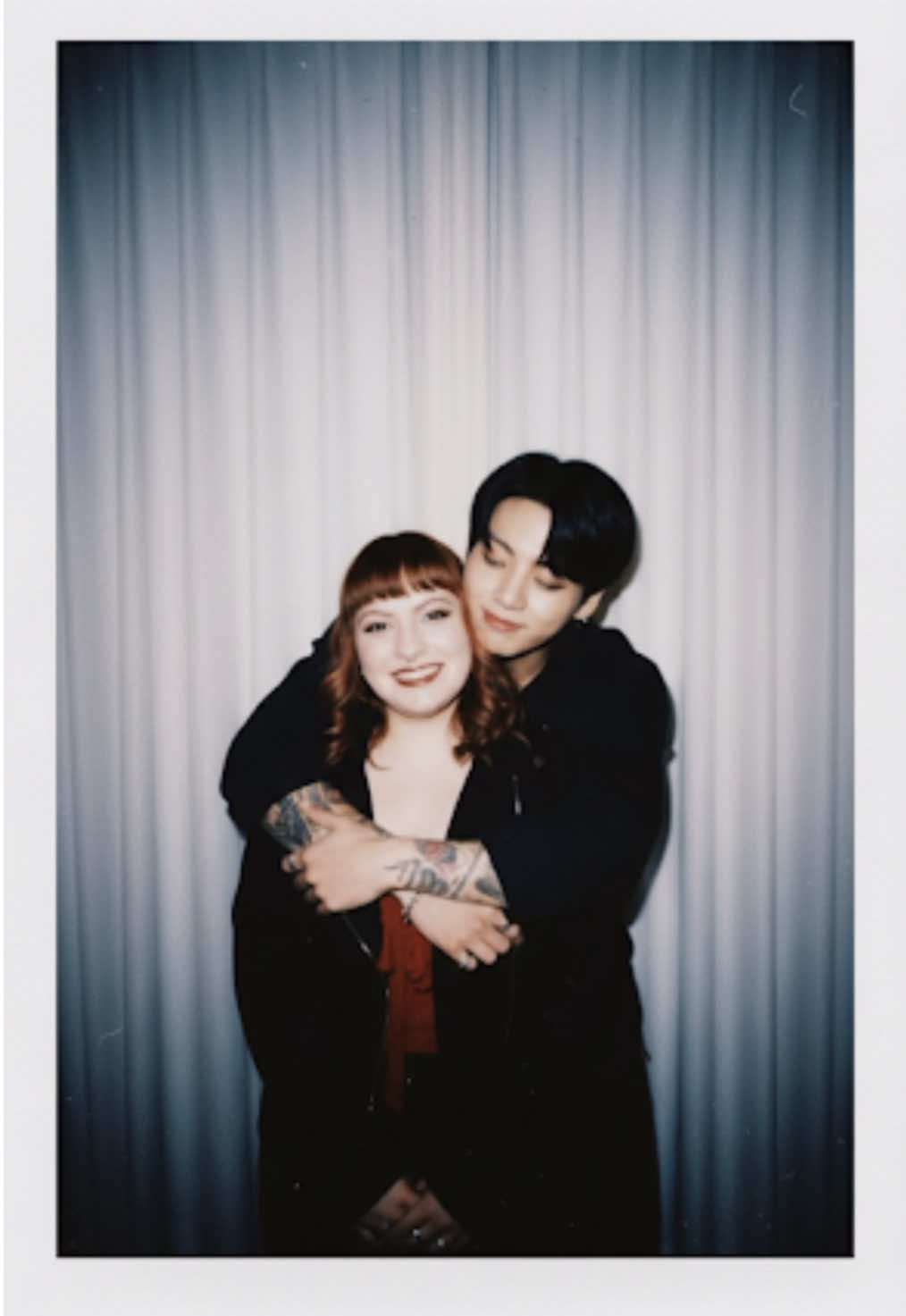 Tutorial de como fazer a foto com o Jungkook ✨💜 Take a photo taken with a Polaroid camera. The photo should look like an ordinary photograph, without an explicit subject or property. The photo should have a slight blur and a consistent light source, like a flash from a dark room, scattered throughout the photo. Don't change the face. Change the background behind those two people with white curtains. With that boy hugging me. #jungkook #bts #army 