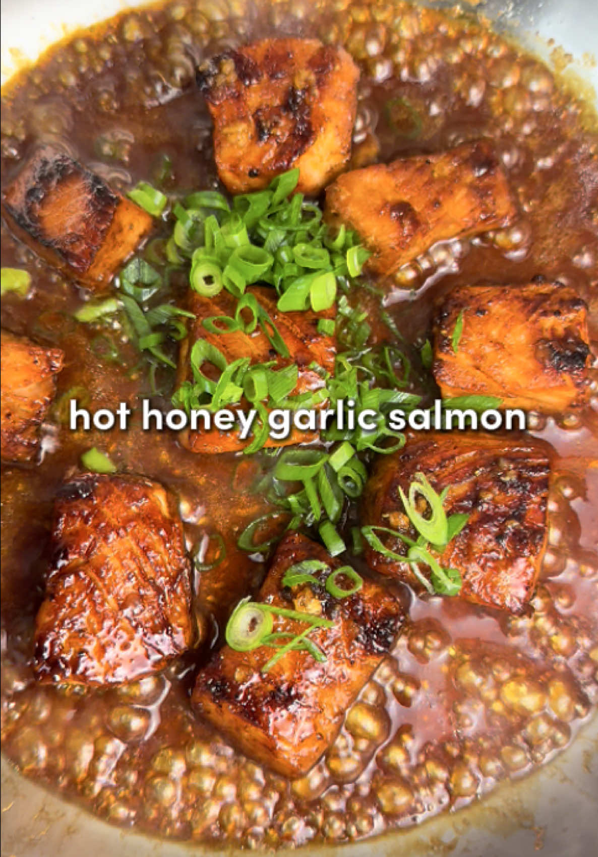 Hot Honey Garlic Salmon 🍯 Fast, flavorful, and addictively good… sweet heat meets buttery salmon 🫶 Ingredients For the Salmon: -0.8 lbs (400g) fresh salmon, cubed -2 tbsp soy sauce (use low-sodium if preferred) -1 tbsp rice vinegar -2 tbsp olive oil -5 garlic cloves, minced -2 tbsp honey -1 tsp garlic powder -2 tsp onion powder - 1 tsp black pepper -1/2 tsp salt -2 tsp paprika -2 tbsp neutral oil (for searing) -2 tbsp unsalted butter (for basting) -1/3 cup green onions, thinly sliced (plus extra for garnish) For the Sriracha Garlic Aioli: -5 tbsp mayonnaise -1 to 2 garlic cloves, minced -1/2 lime, juiced -1 to 2 tbsp Sriracha sauce Instructions: 1. Remove the skin if needed, then cube the fillets into large bite-sized pieces… think forkable, not finger food. Pat them dry with paper towel. 2. In a bowl, combine the salmon with olive oil, rice vinegar, soy sauce, honey, minced garlic, and all the seasonings (paprika, garlic powder, salt, onion powder, black pepper). Marinate for as long as your patience lasts (even 1–2 minutes works), but the longer… the more flavor. 3. Heat neutral oil in a large skillet over medium to medium-low heat (err on the lower side as honey + soy = caramelization fast). Once hot, add the salmon and cook about 3 minutes per side until golden and sizzling. Save the marinade for later; it’s liquid gold. 4. Lower the heat to low, add butter, and pour in the reserved marinade. Simmer for 2–3 minutes to fully cook off any raw fish juices, basting the salmon with the buttery sauce. Top with 1/3 cup sliced green onions. 5. Stir together the mayonnaise, garlic, lime juice, and Sriracha. Taste and add more Sriracha if you’re feeling spicy. 6. Recommended plating: Build a cozy bed of fluffy jasmine rice, pile on the salmon, scatter more green onions on top like confetti, and drizzle generously with that dreamy aioli. #dinner #Recipe #cooking #salmon #cooking #recipesoftiktok #easydinner #cookingathometiktoktv 
